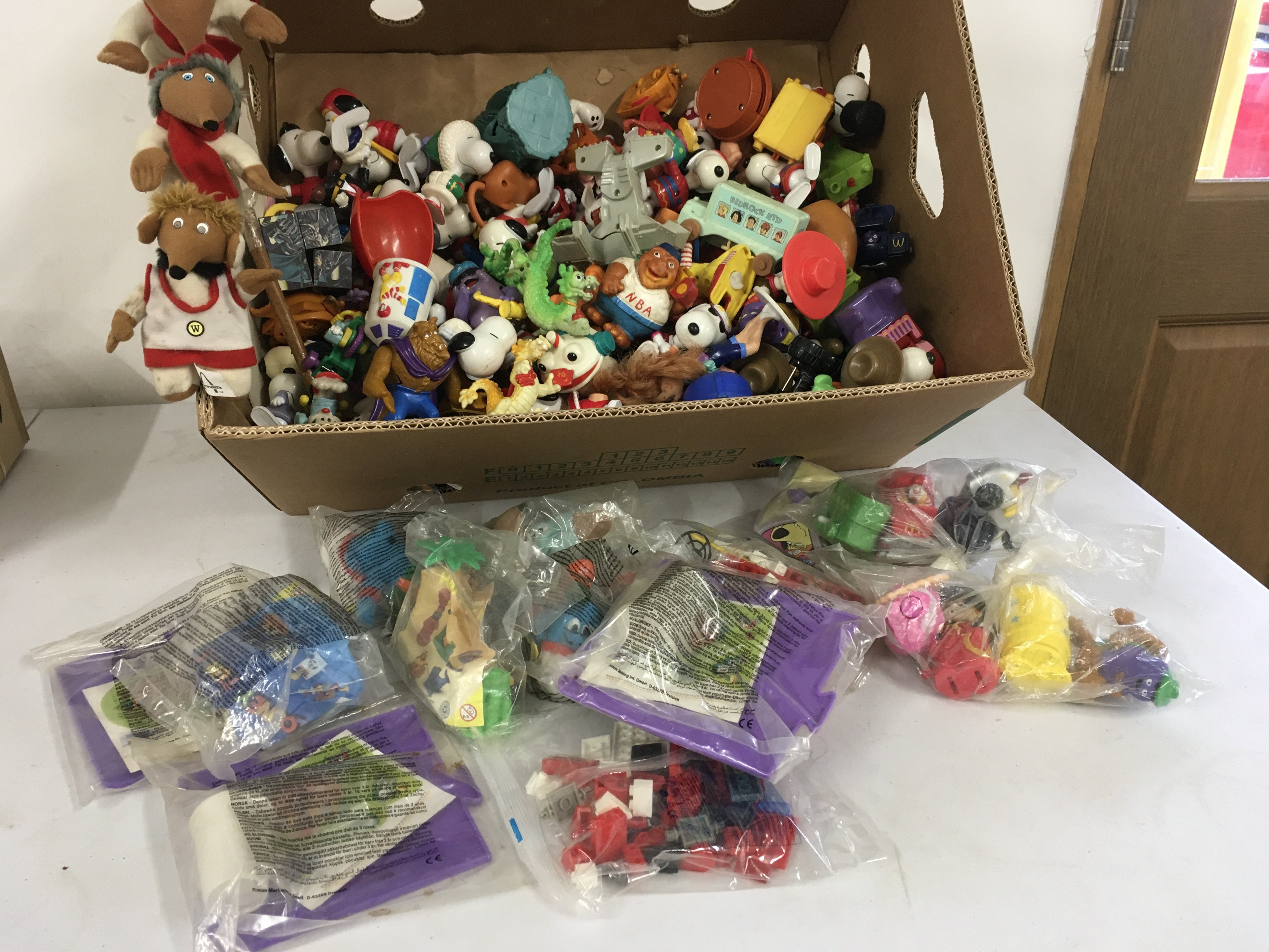 A box containing a large number of figures depicting many characters including Snoopy..Wombles..etc.  includes toys issued with McDonalds food some unopened.  No reserve 