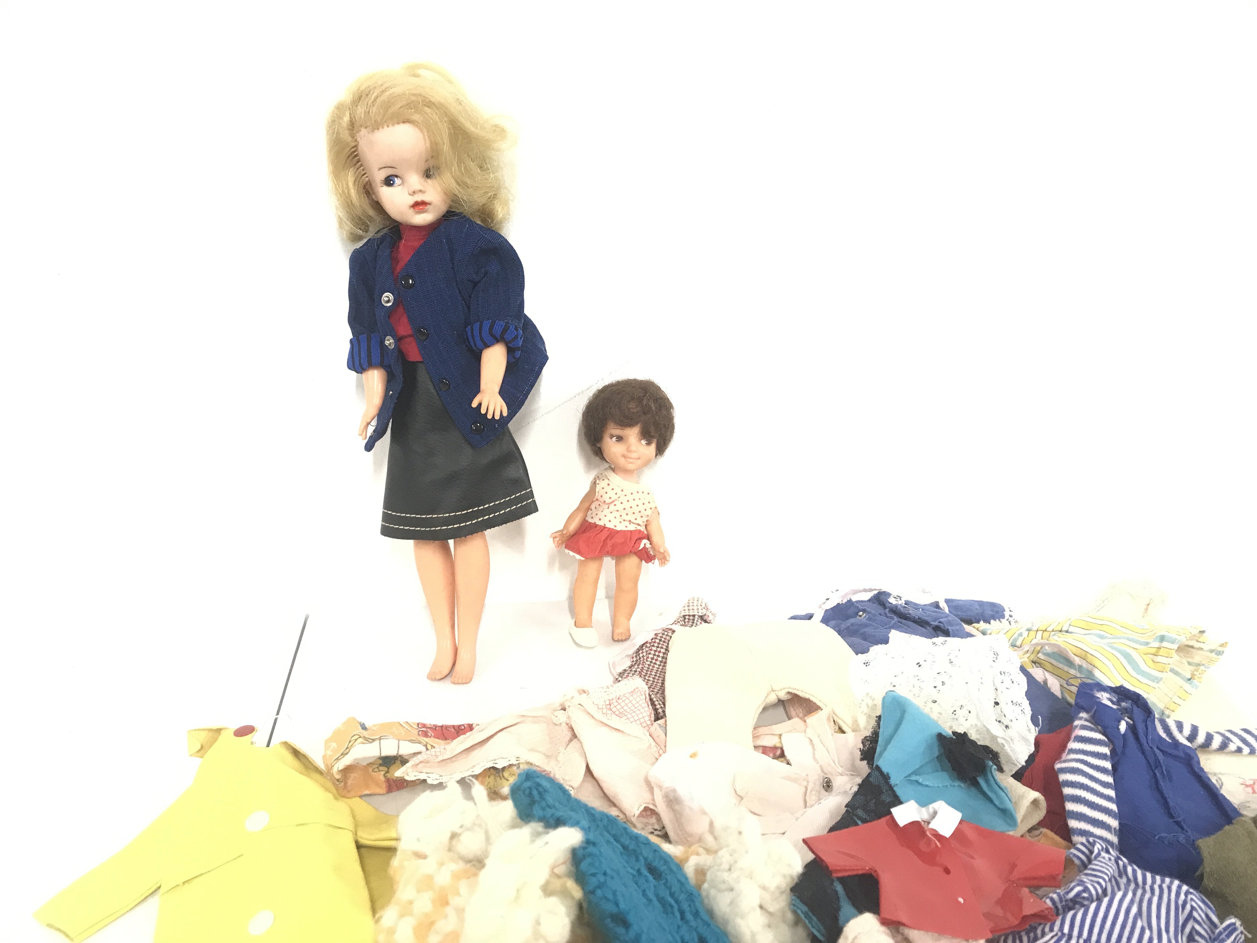 A Vintage Sindy Doll Various Clothes And One Other Doll.