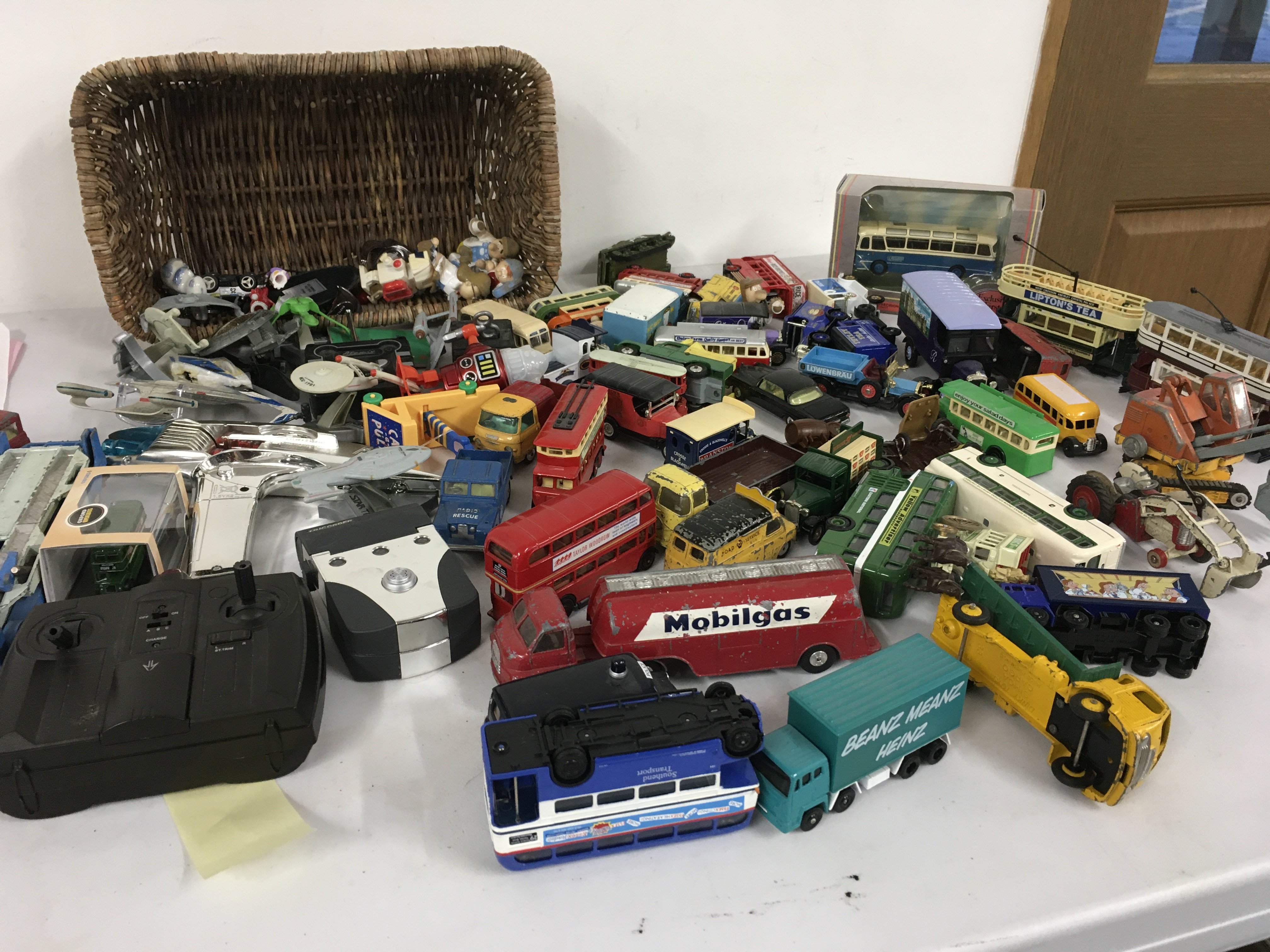 A mixed collection of Playworn diecast cars..buses and trucks.  Also includes Star Trek  phaser and  Tri order plus spaceships and other pieces.  