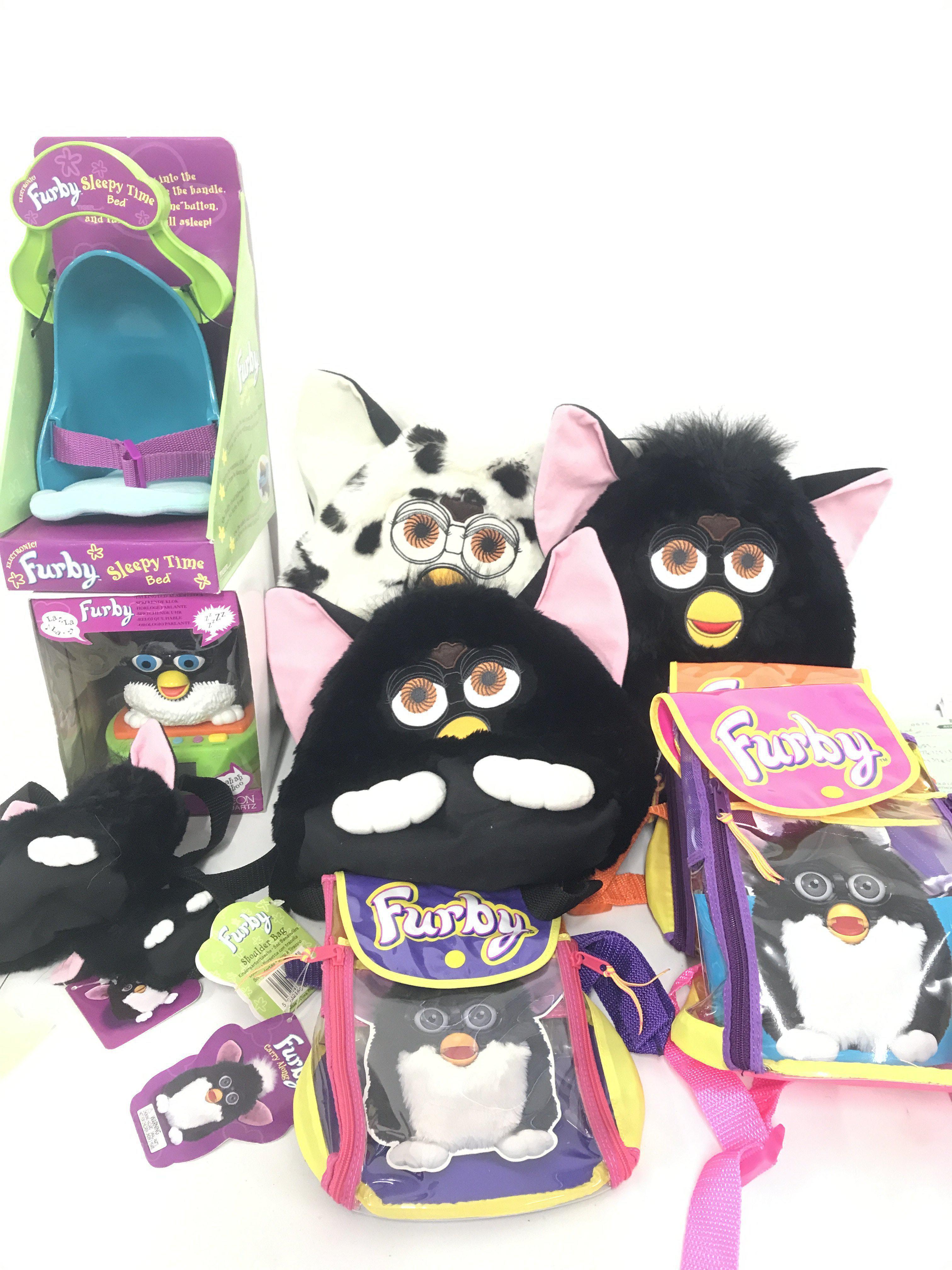 A Collection Of Furby Accessories Including Alarm Clock. Carry Along Bags. Sleepy Time Bed. Backpacks etc.