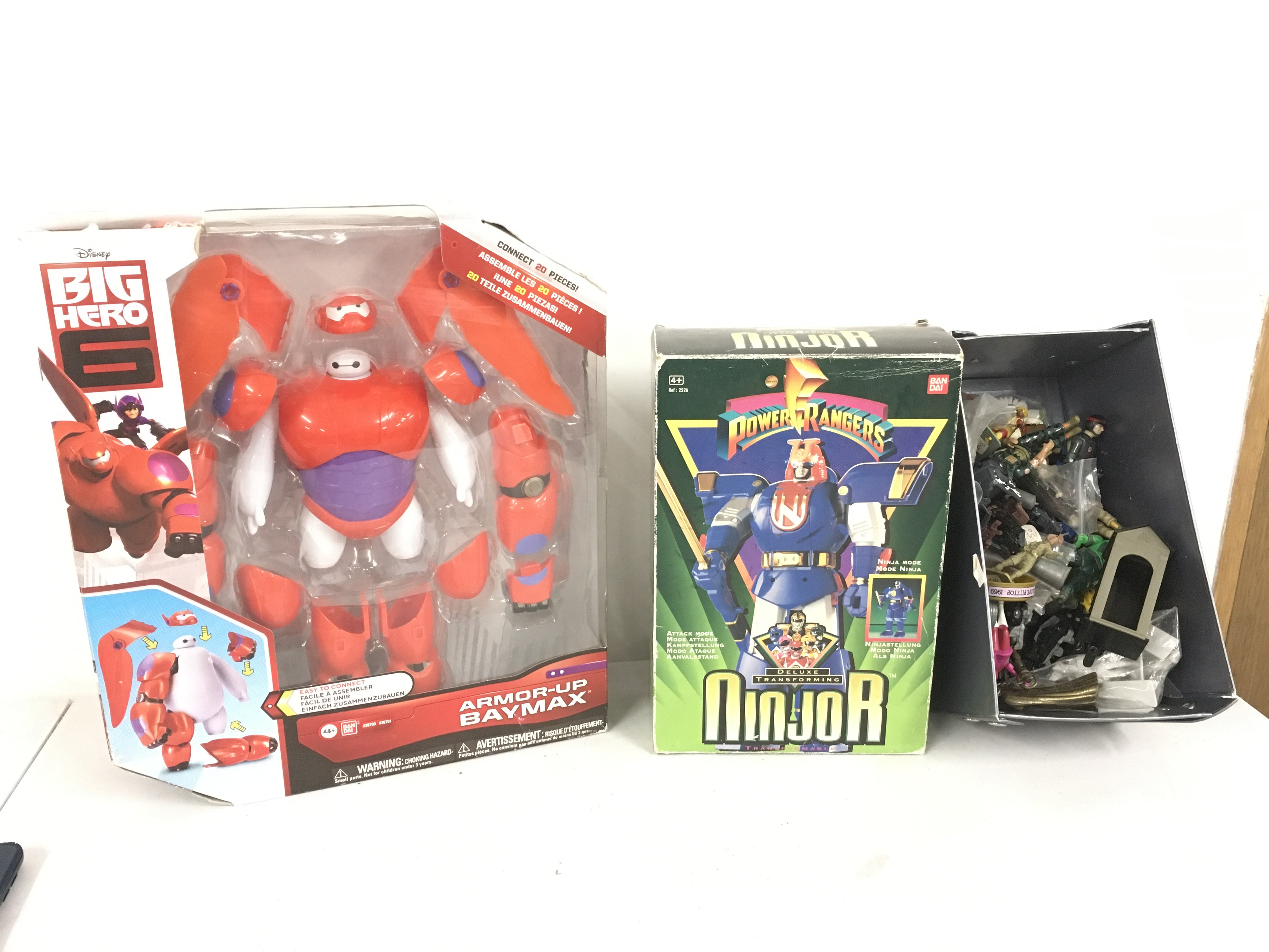 A collection of model action figures including boxed Disney Big Hero and boxed Power Rangers deluxe transforming Ninjor plus box contains in excess of 30 figures some vintage across several themes.  No reserve