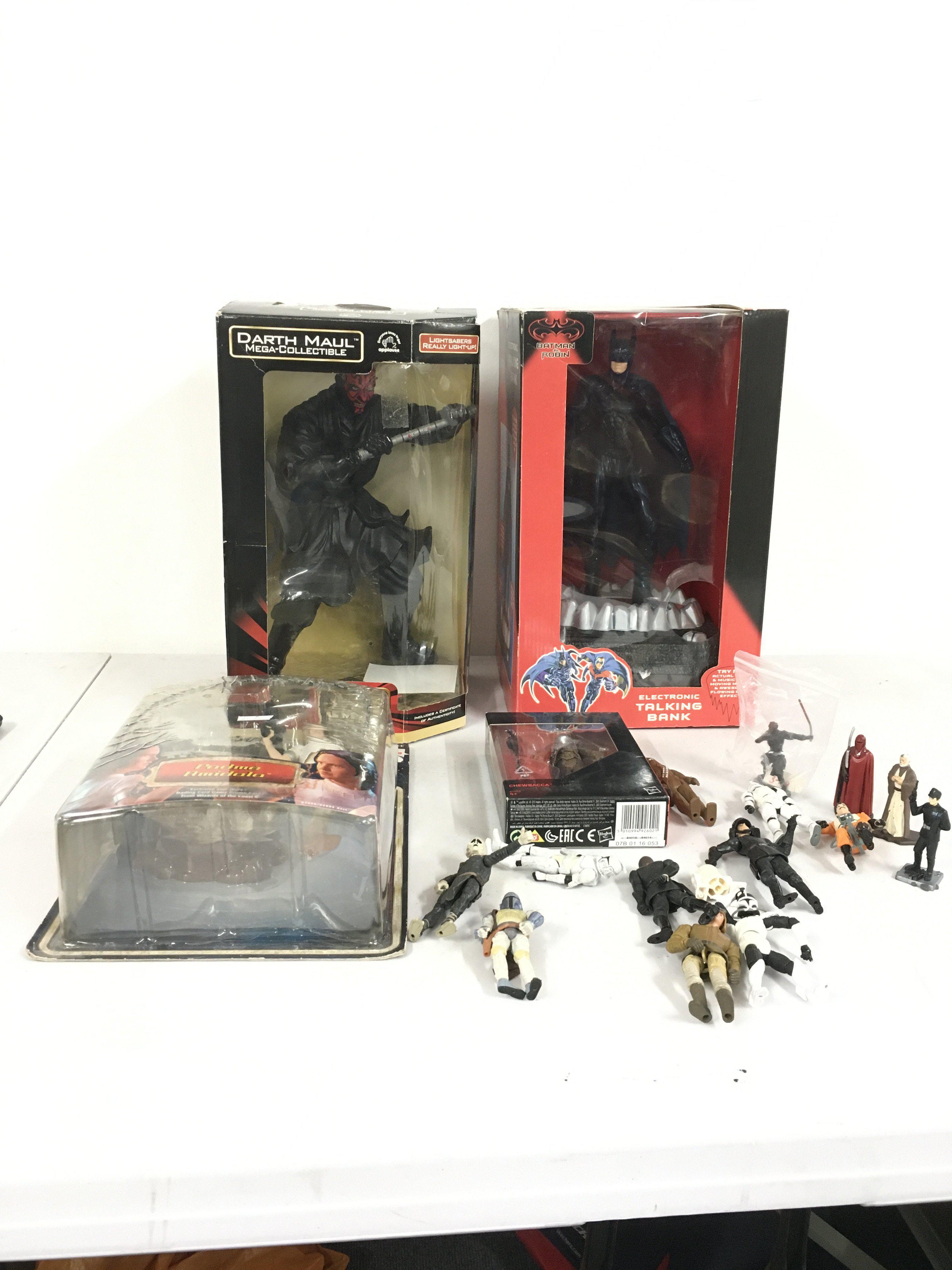 A collection of Star Wars action figures including boxed Darth Maul with light up lightsaber.. Padme Amidala on unopened card..a boxed Chewbacca plus 15 small loose figures.  Also included a boxed Batman talking bank.  No reserve 