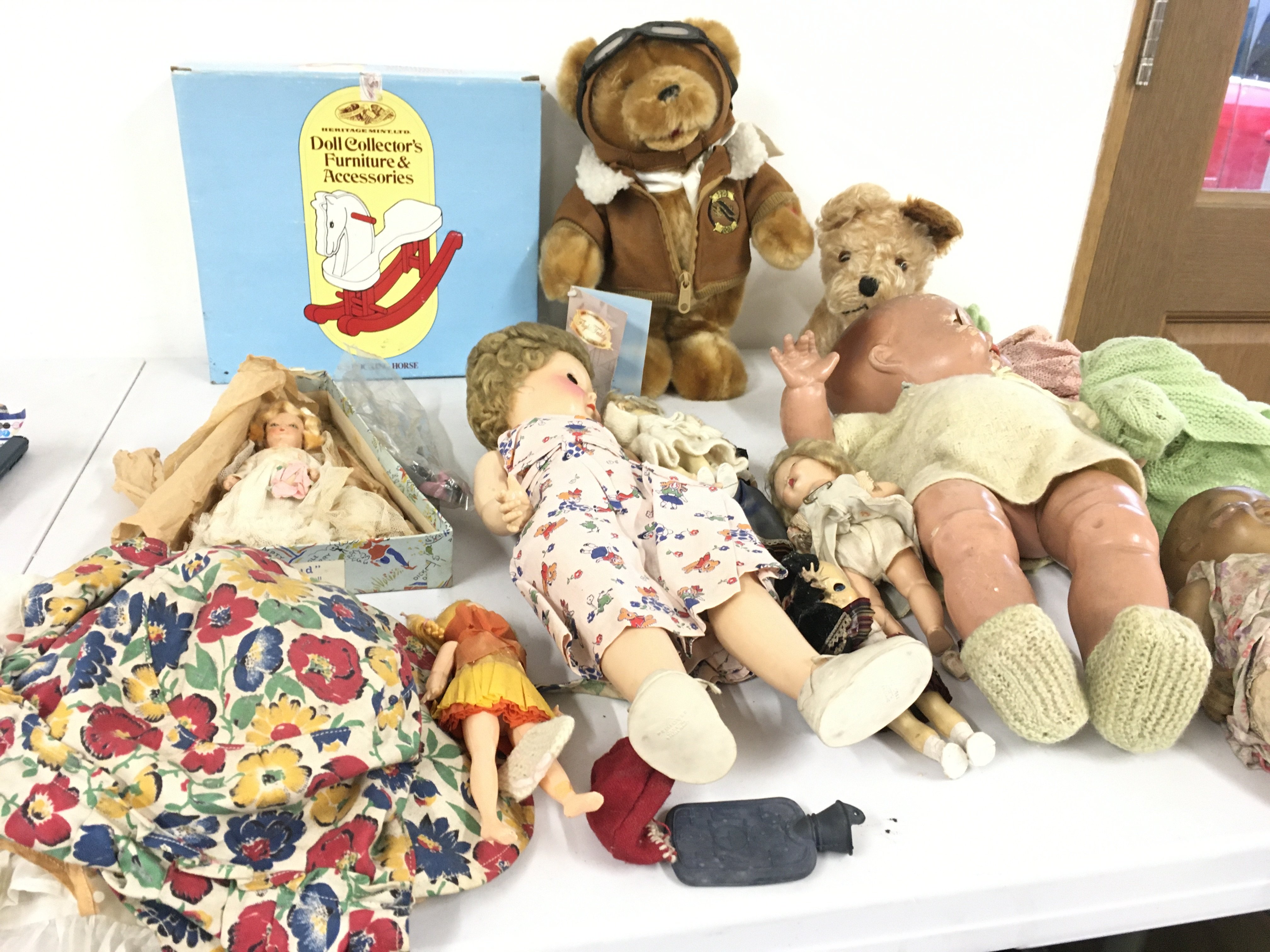 A collection of vintage dolls with assorted clothing accessories also soft toys limited edition teddy bear commemorative of 100 years flight.  Plus a dog.  No reserve 