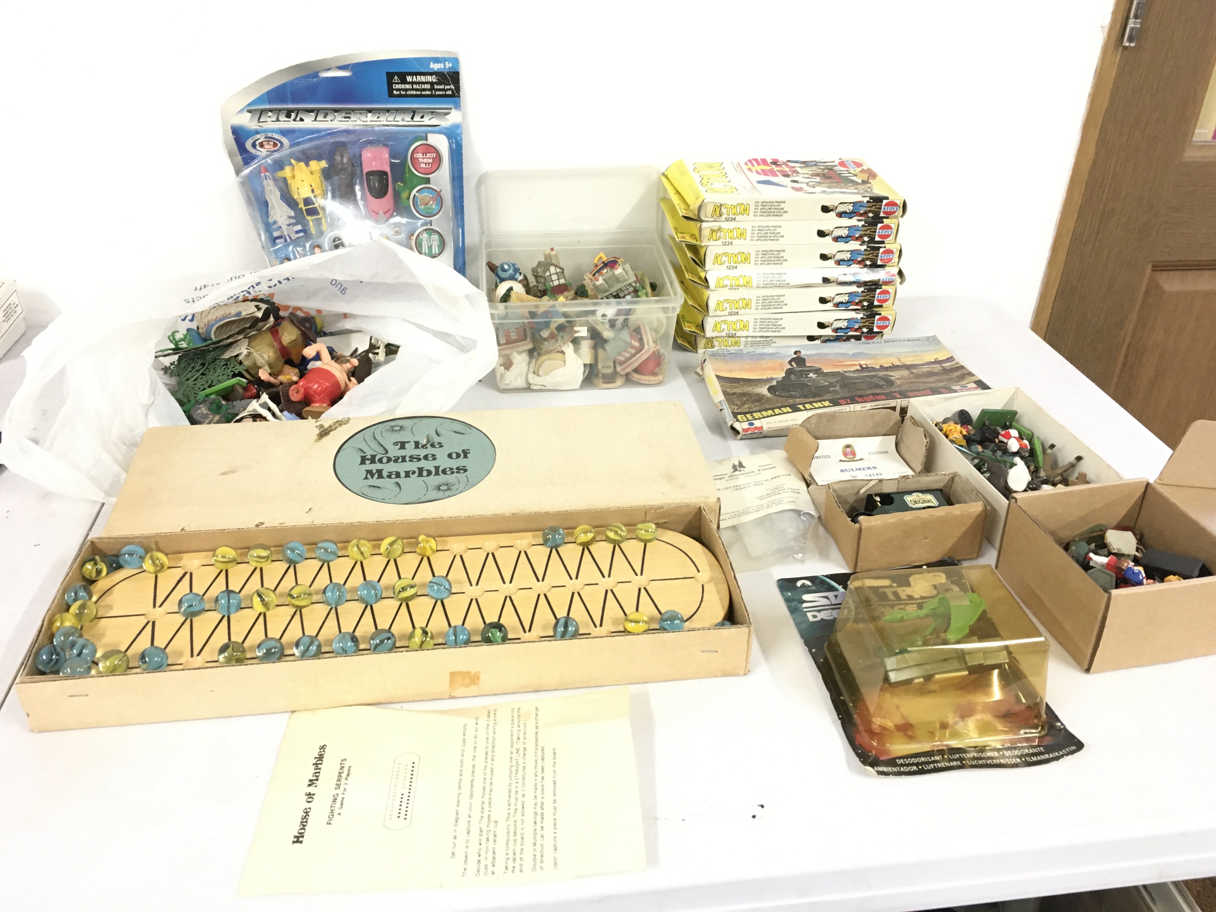 A collection of assorted toys some vintage including boxed The House of Marbles..7 boxes of soldiers by Action..a unopened Thunderbirds figure set..plus other items.  No reserve