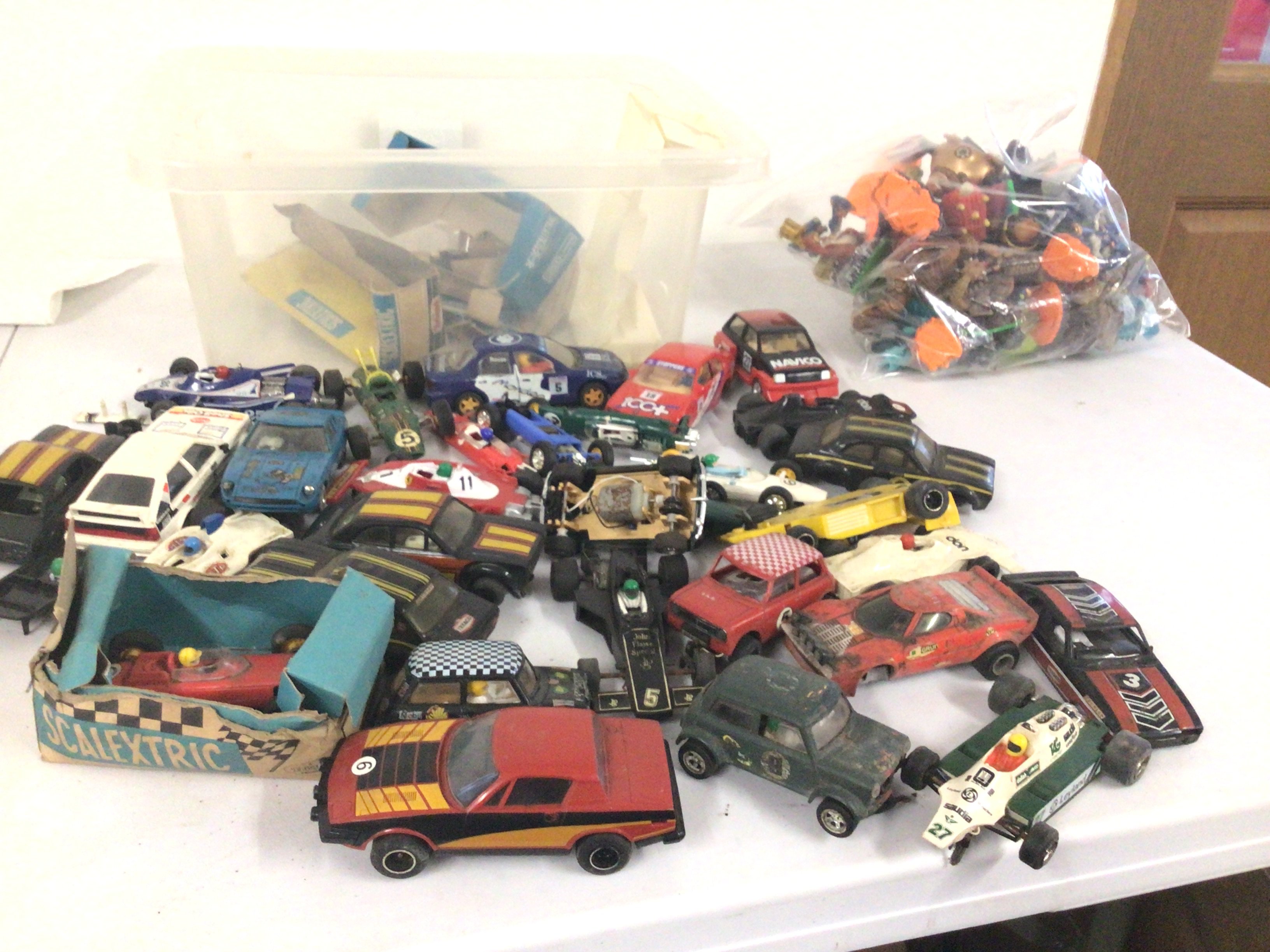 A box containing in excess of 25 Scalextric cars ideal for spares or repair.  Also bag containing Skylander figures.  No reserve