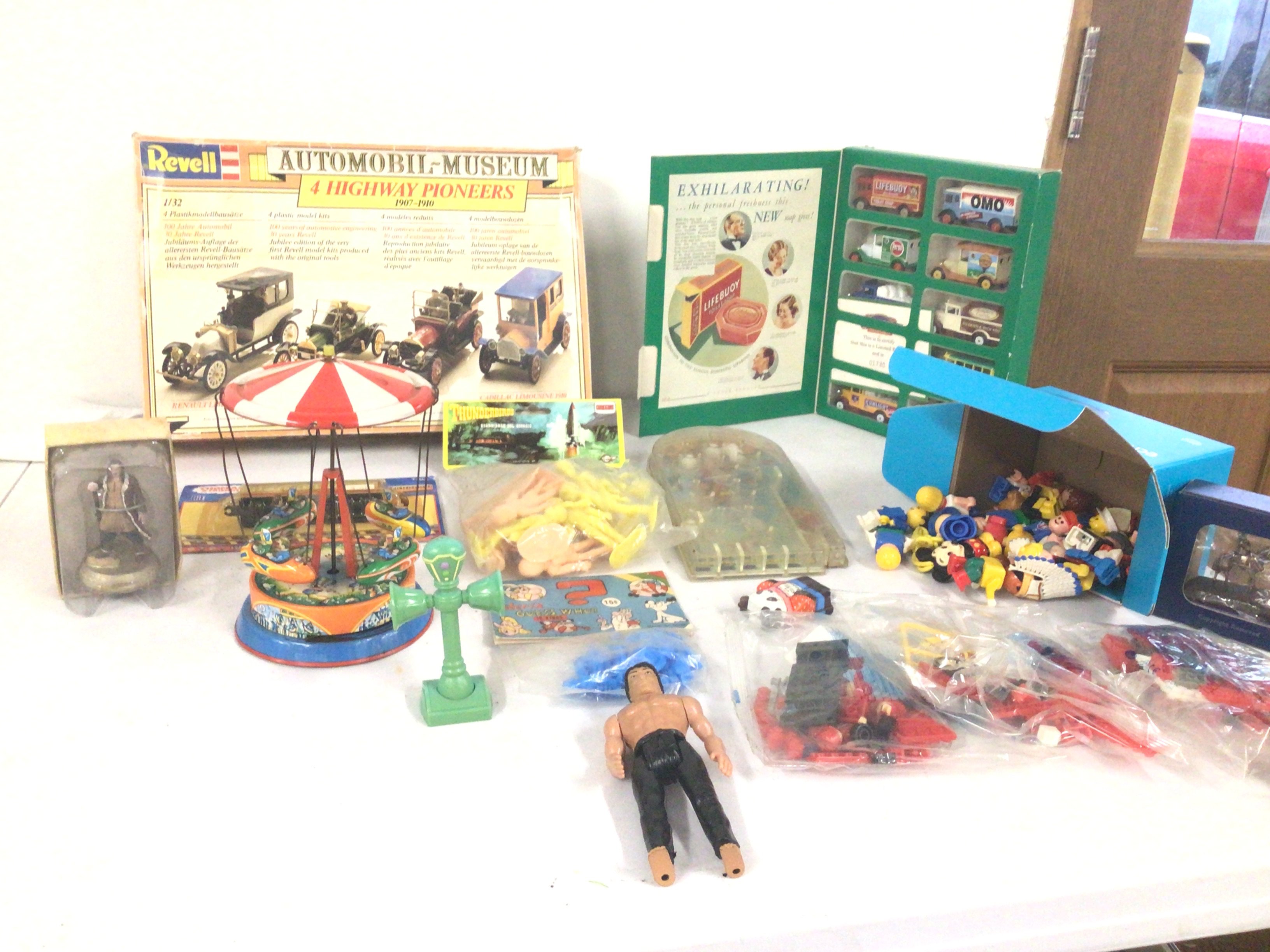 An assorted collection of toys including Revell car kit..tin plate fairground ride..Thunderbirds figures and Asterix..Lego sets.figures etc.  no reserve