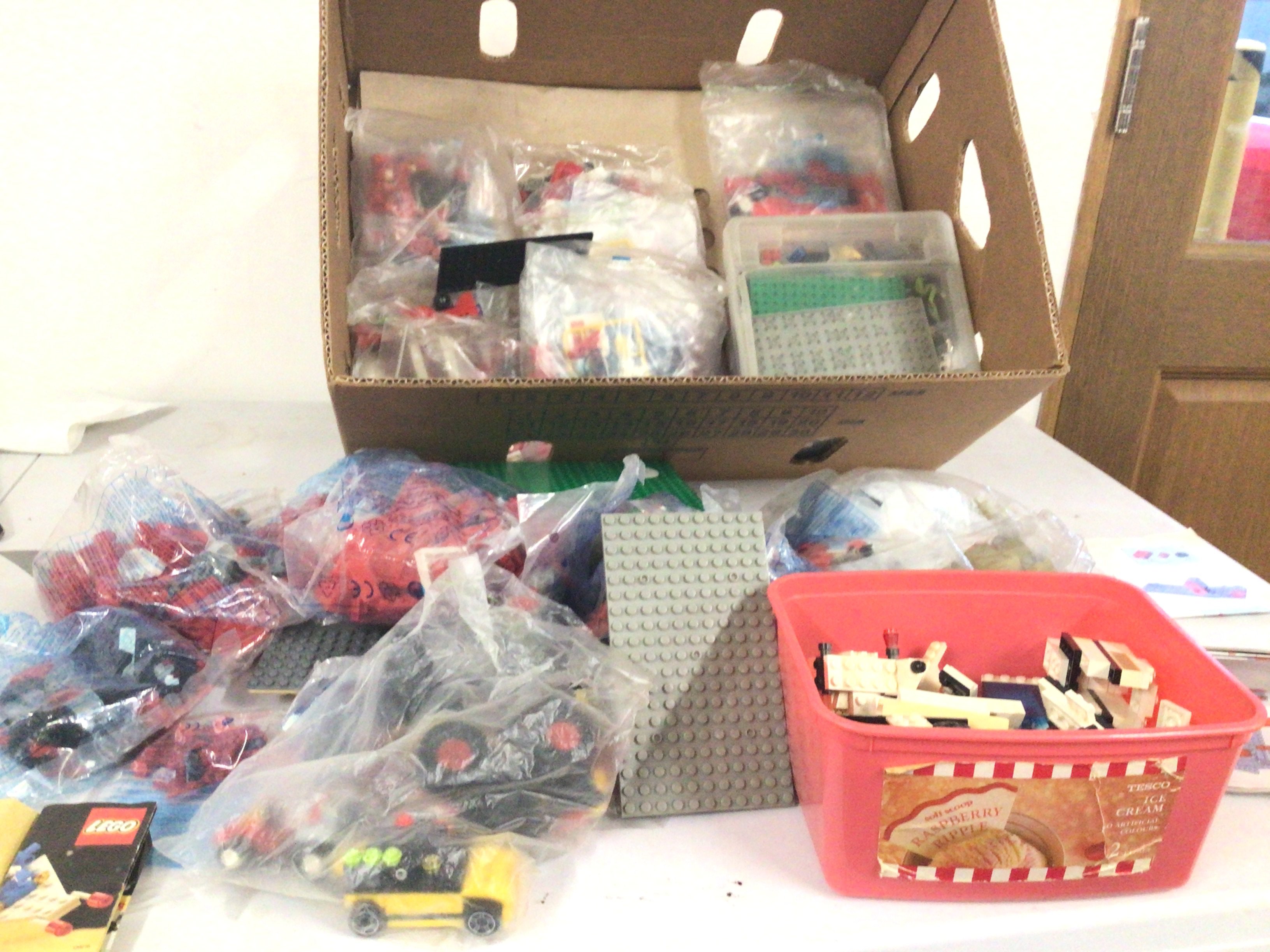 A large collection of Lego pieces some in sealed bags others loose in boxes and open bags.  Some instructions.  No reserve.