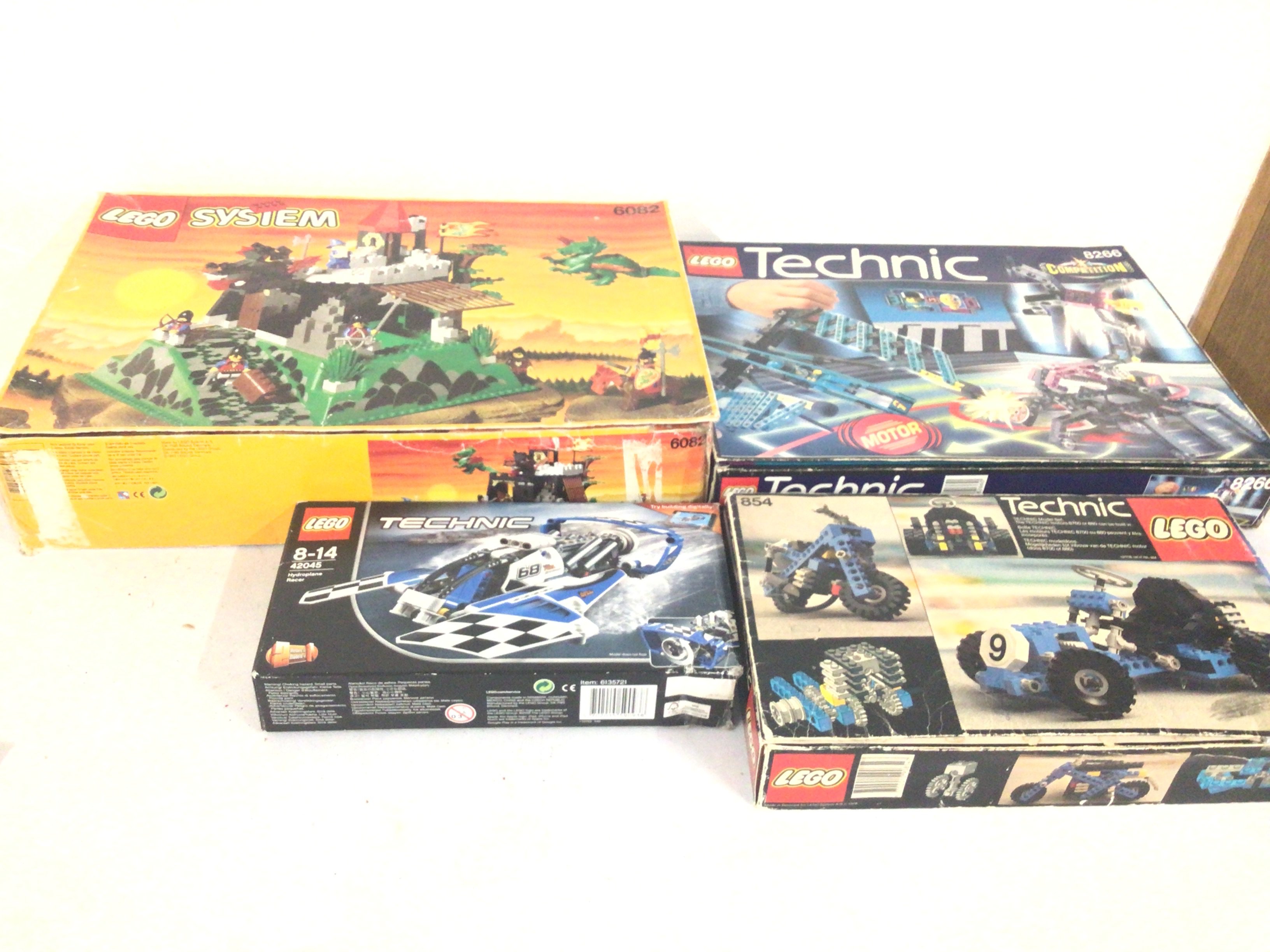 A collection of four boxed previously owned Lego sets featuring 6082..Â¦8266.  Â¦854. Â¦42045..possible incomplete viewing recommended.  No reserve