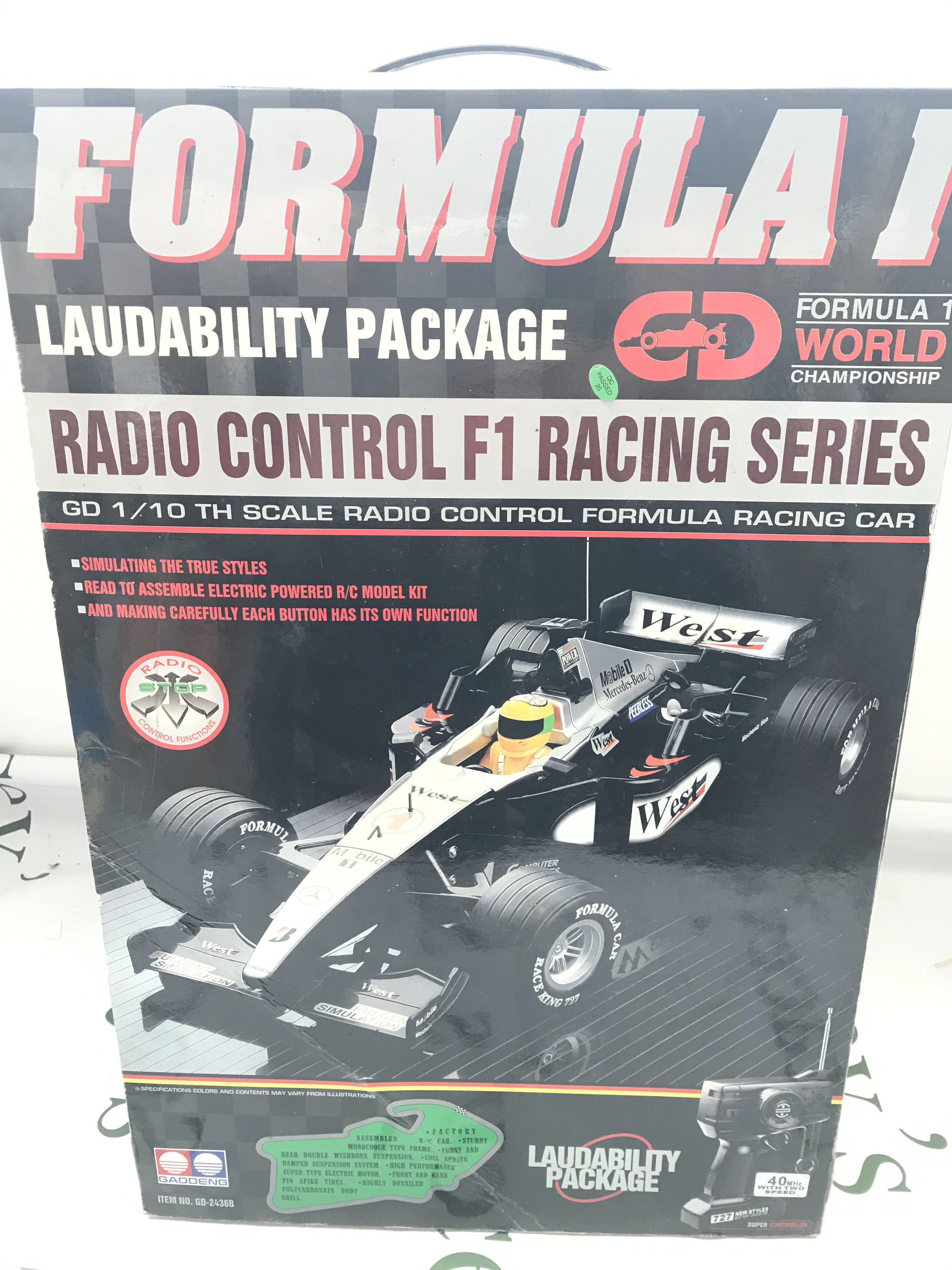 A Boxed Gaoodeng F1 R/C Racing Car. A Scalextric Jaguar Challenge Set And A Christmas Holiday Train Set.(3)