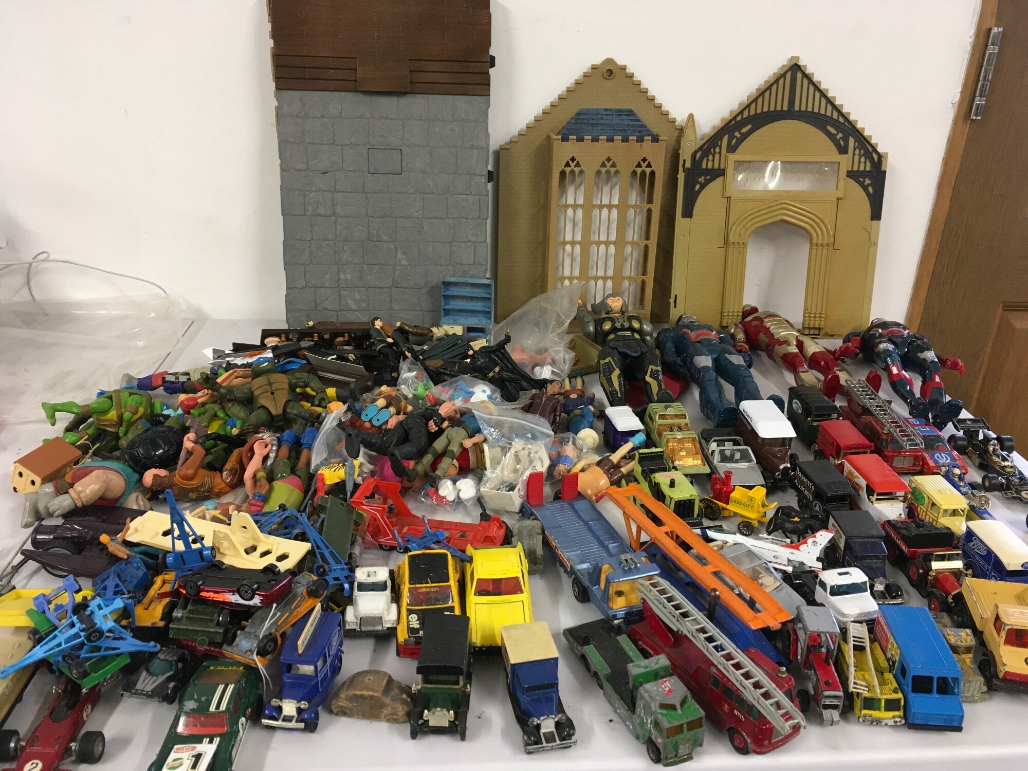 A mixed collection of action figures featuring Harry Potter, TMNTurtles, Ironman etc.  plus a collection of diecast vehicles.  No reserve.