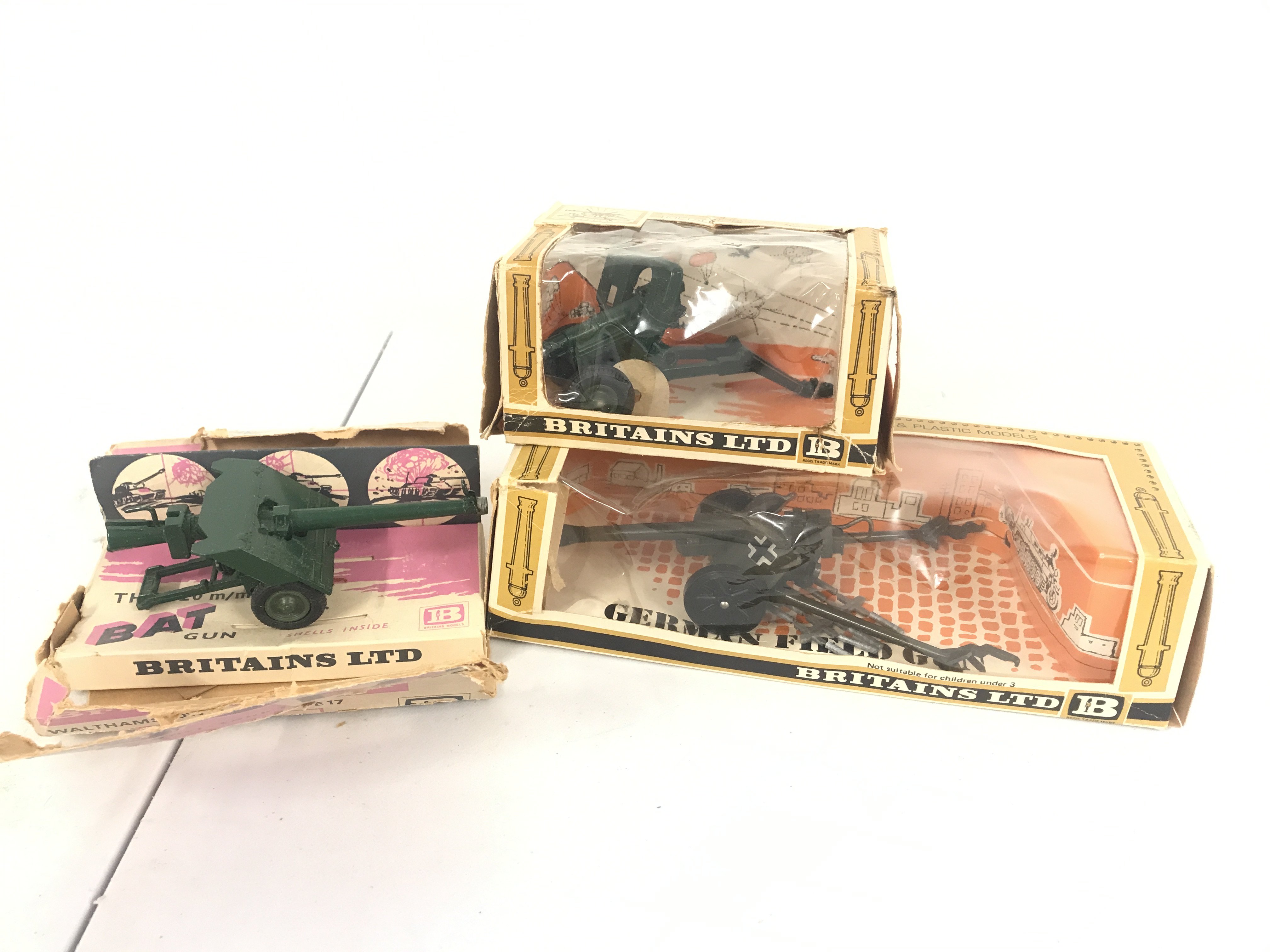 3 X Boxed Britains Guns Including A 105MM Pack Howitzer #9724. A German Field Gun #9732 (With Shells) And A Bat Gun. Boxes In Various States.