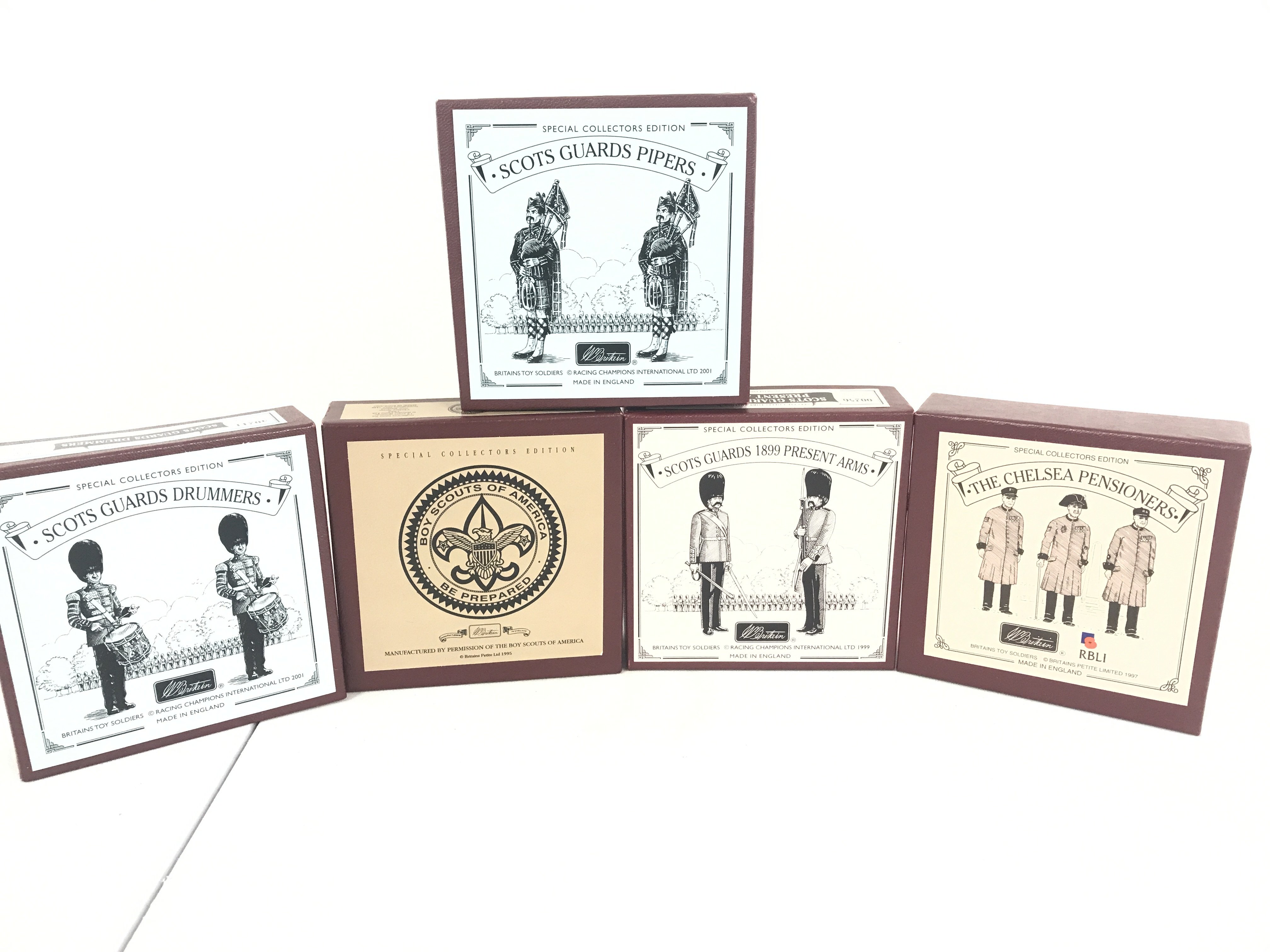 A Collection Of Boxed Britains Figures Including Scots Guards Drummer #40211. Boy Scouts Of America #5971. Scots Guards Pipers #40210. Scots Guards 1899 Present Arms #00256  And Chelsea Pensioners.(5).