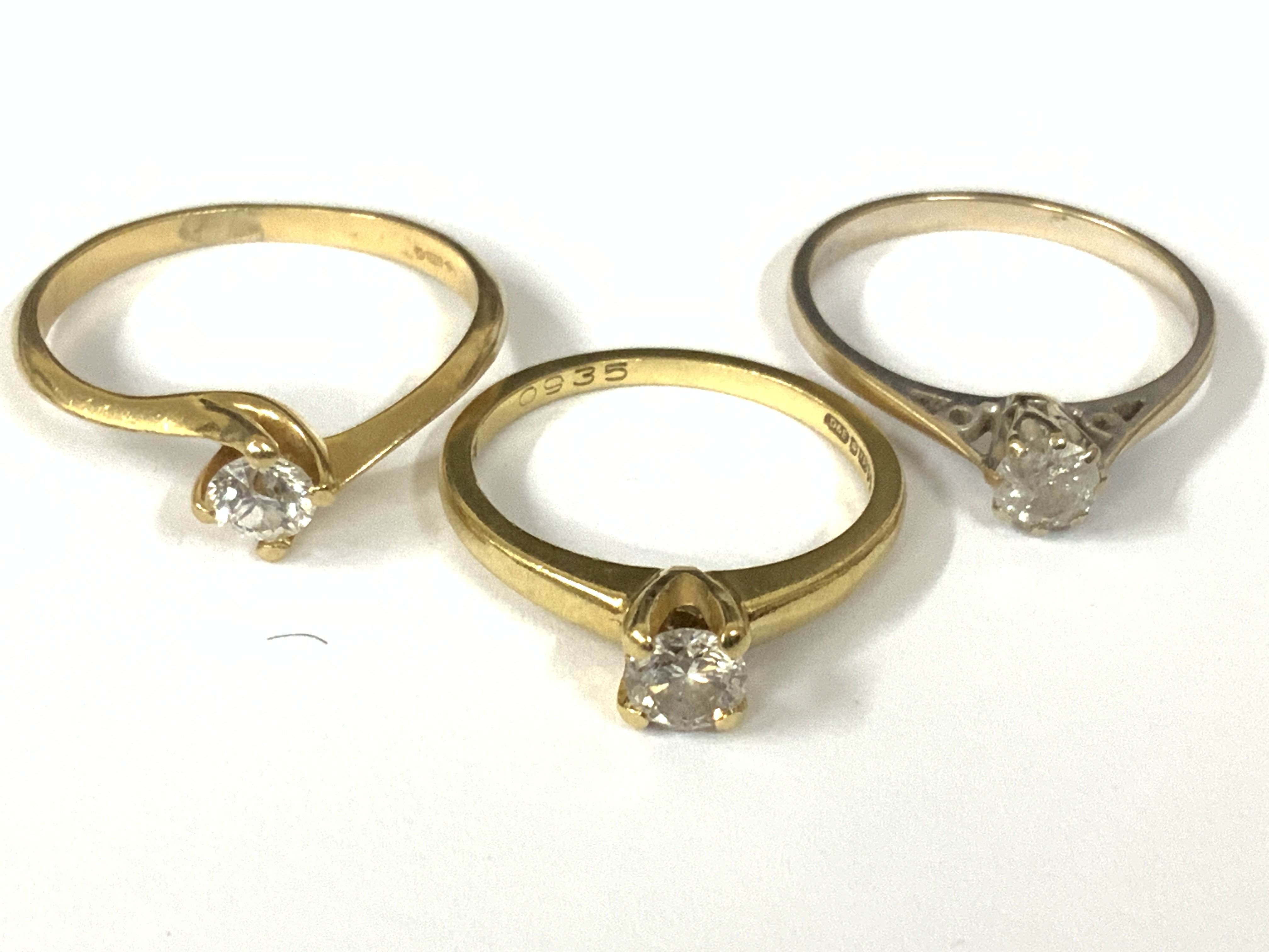 Three 18ct white gold diamond solitaires (x1 white gold). Approx ring size L,N,Q. Approx 7.3g. Postage category A