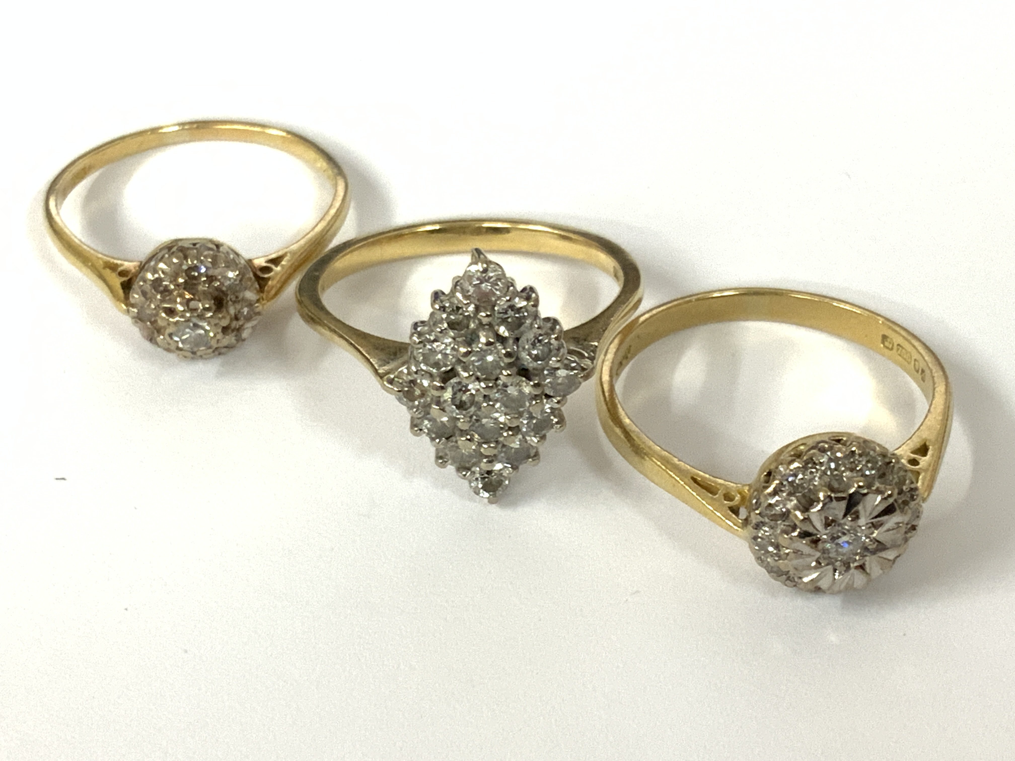 Three 18ct gold diamond cluster rings. Approx ring size M,N,P. Approx 9.6g. Postage category A