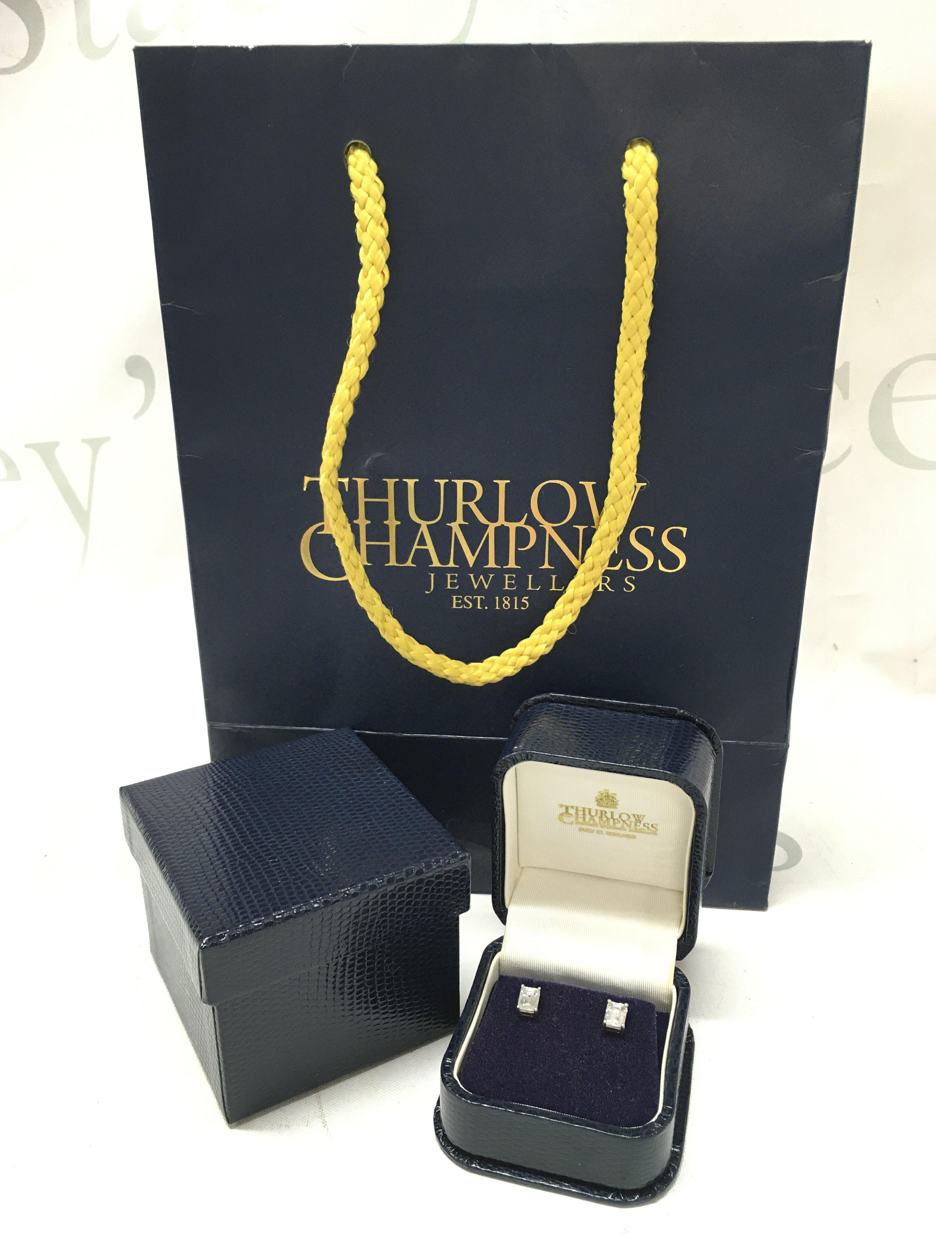 A pair of 18ct white gold emerald cut diamond earrings totalling 1.47 carat, with bag and receipt