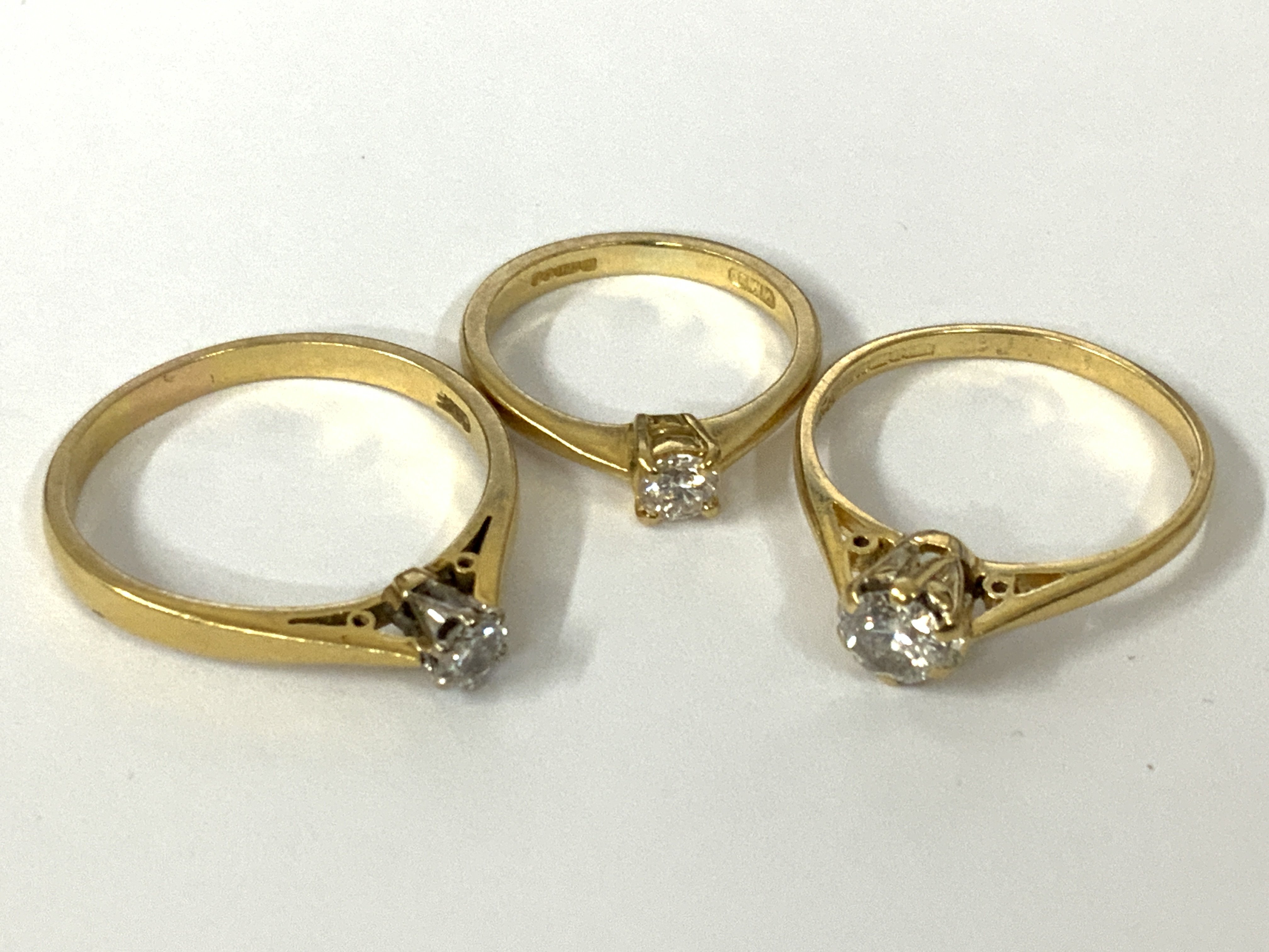 Three 18ct gold diamond solitaire rings. Approx ring size G, N, Q. Approx 7.2g. Postage category A