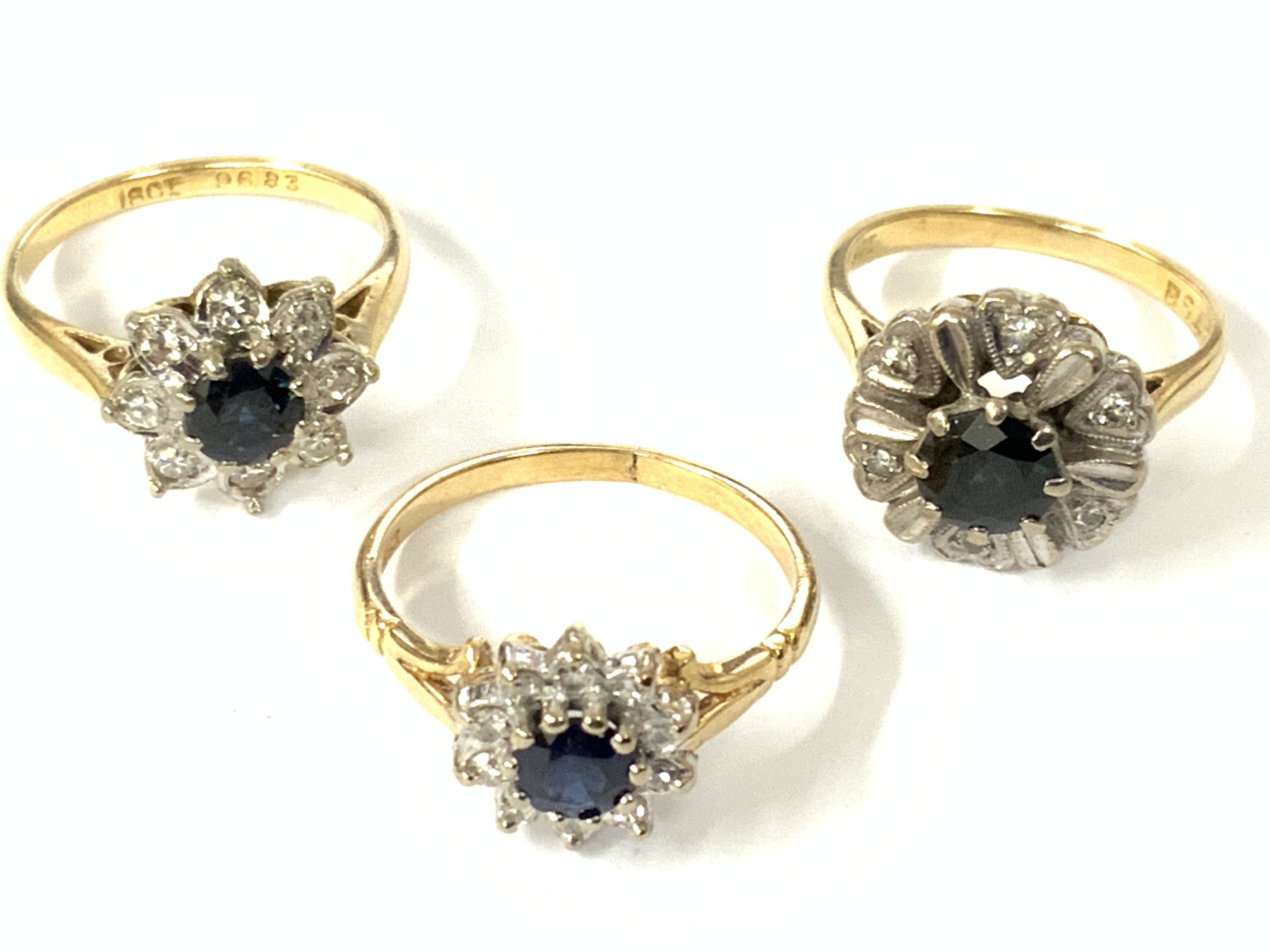 Three 18ct gold sapphire/diamond cluster rings. Approx ring size K,N,M. Approx 12.7g. Postage category A
