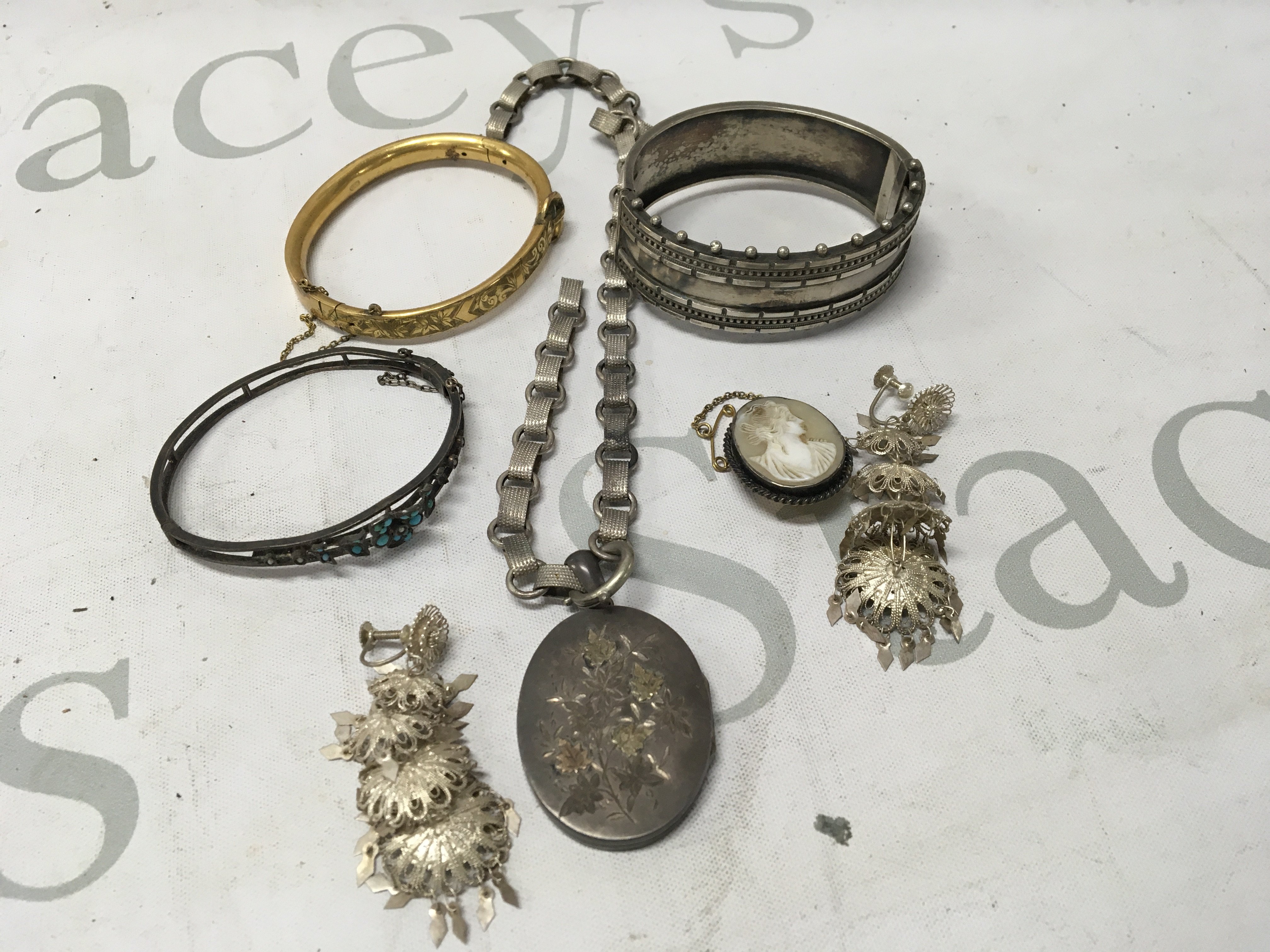 A collection of Edwardian and later jewellery including bangles and necklaces.