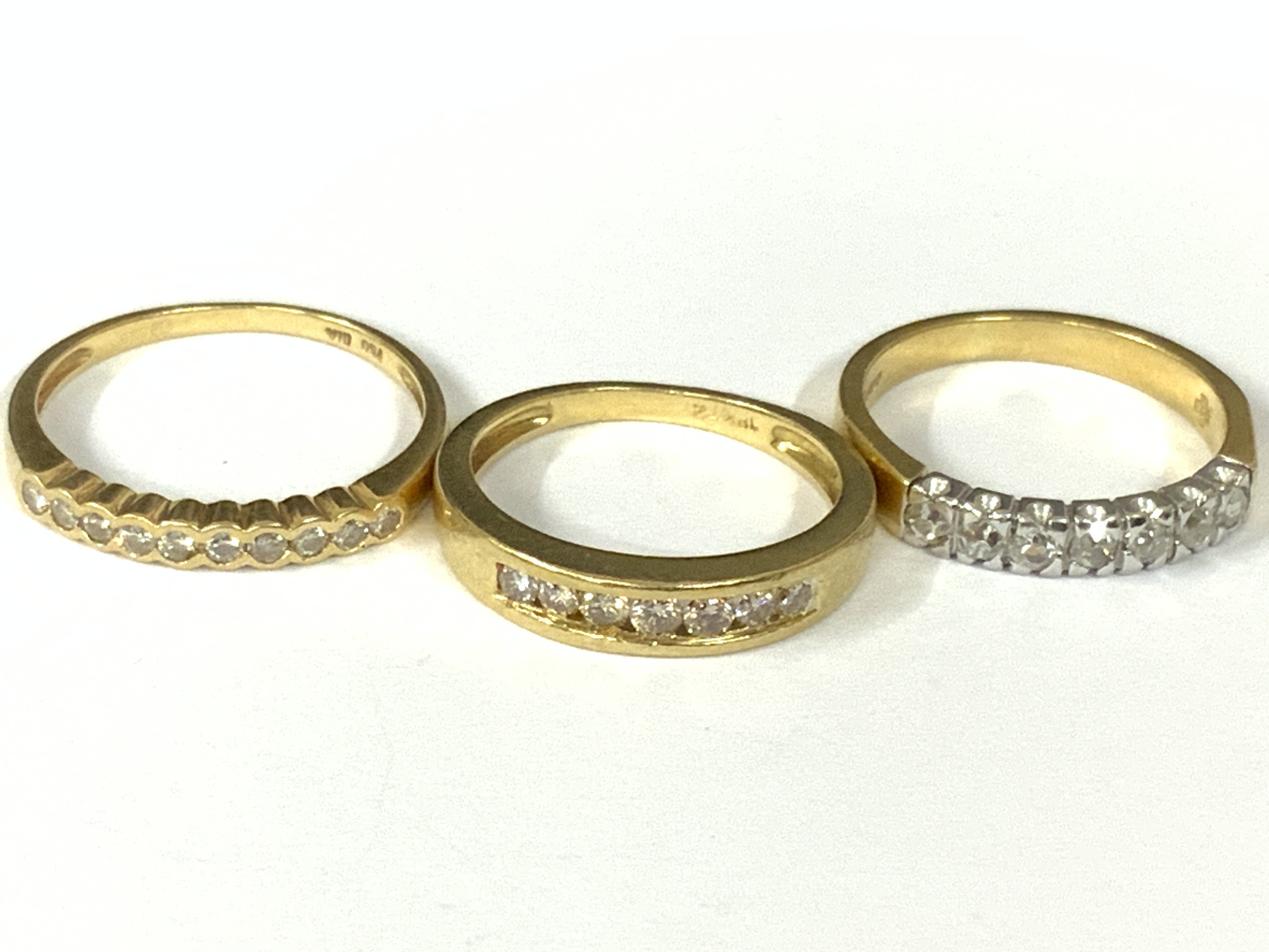Three 18ct gold diamond half hoop rings. Approx ring size K,L,N. Approx 7.8g. Postage category A