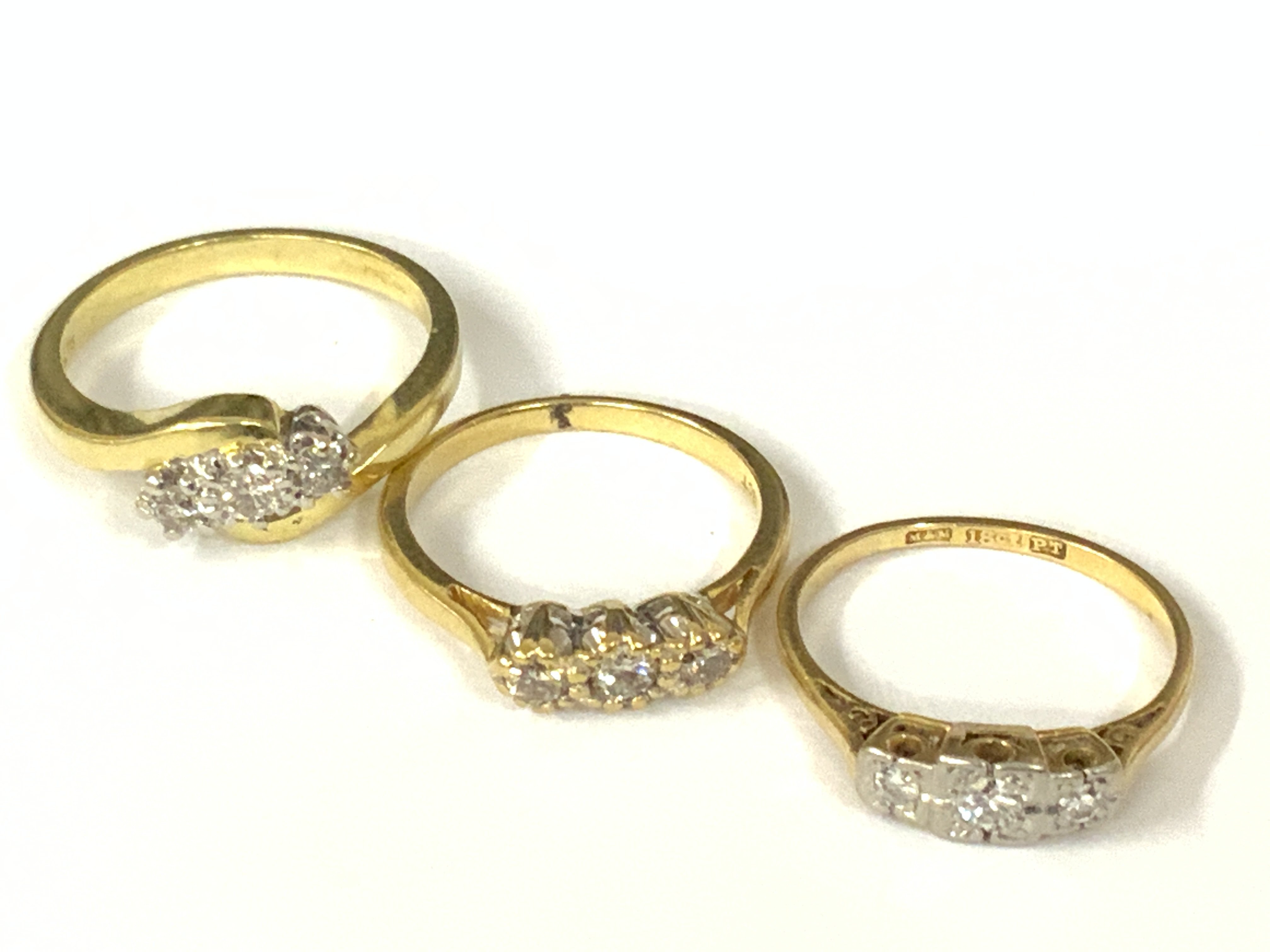 Three 18ct three stone diamond rings. Approx ring size J,N. Approx 8.8g. Postage category A