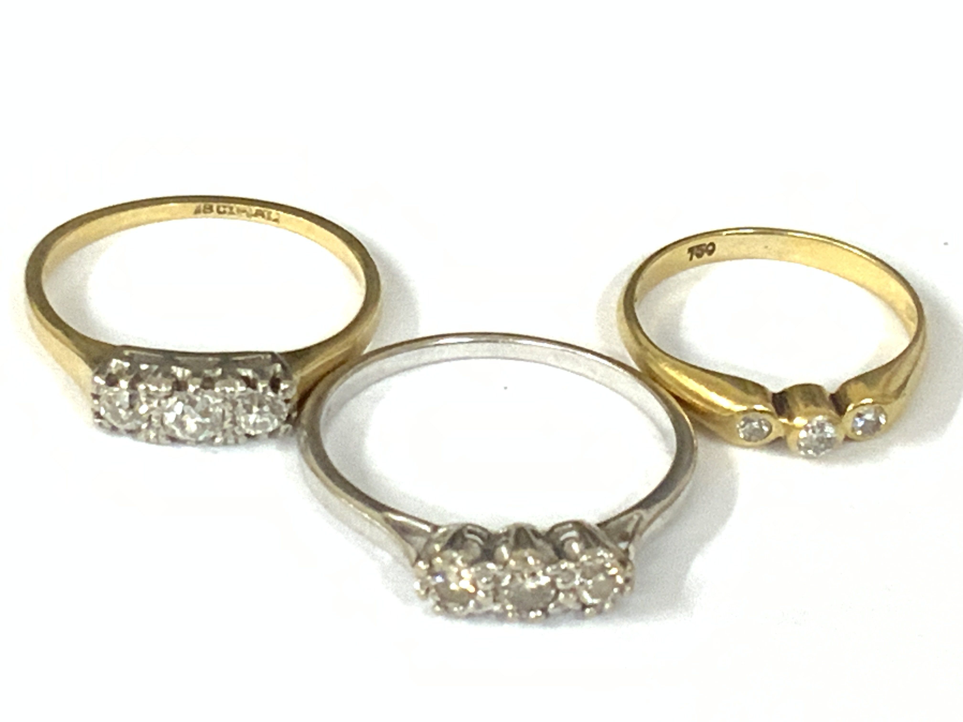 Three 18ct three stone diamond rings. Approx ring size H,M,O. Approx 6.2g. Postage category A
