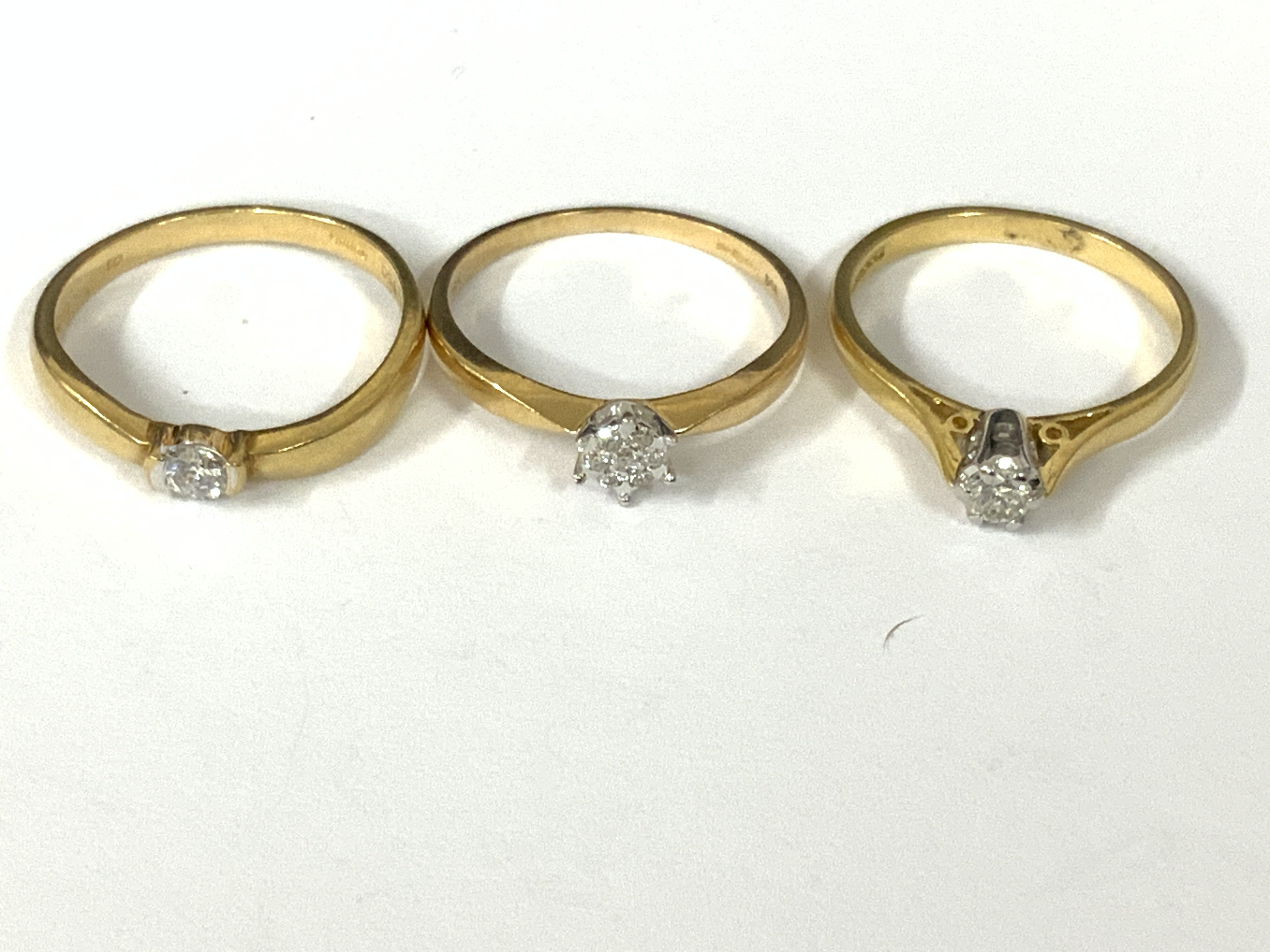 Three 18ct gold diamond solitaire rings. Approx ring size M,N.mapprox 6.5g. Postage category A