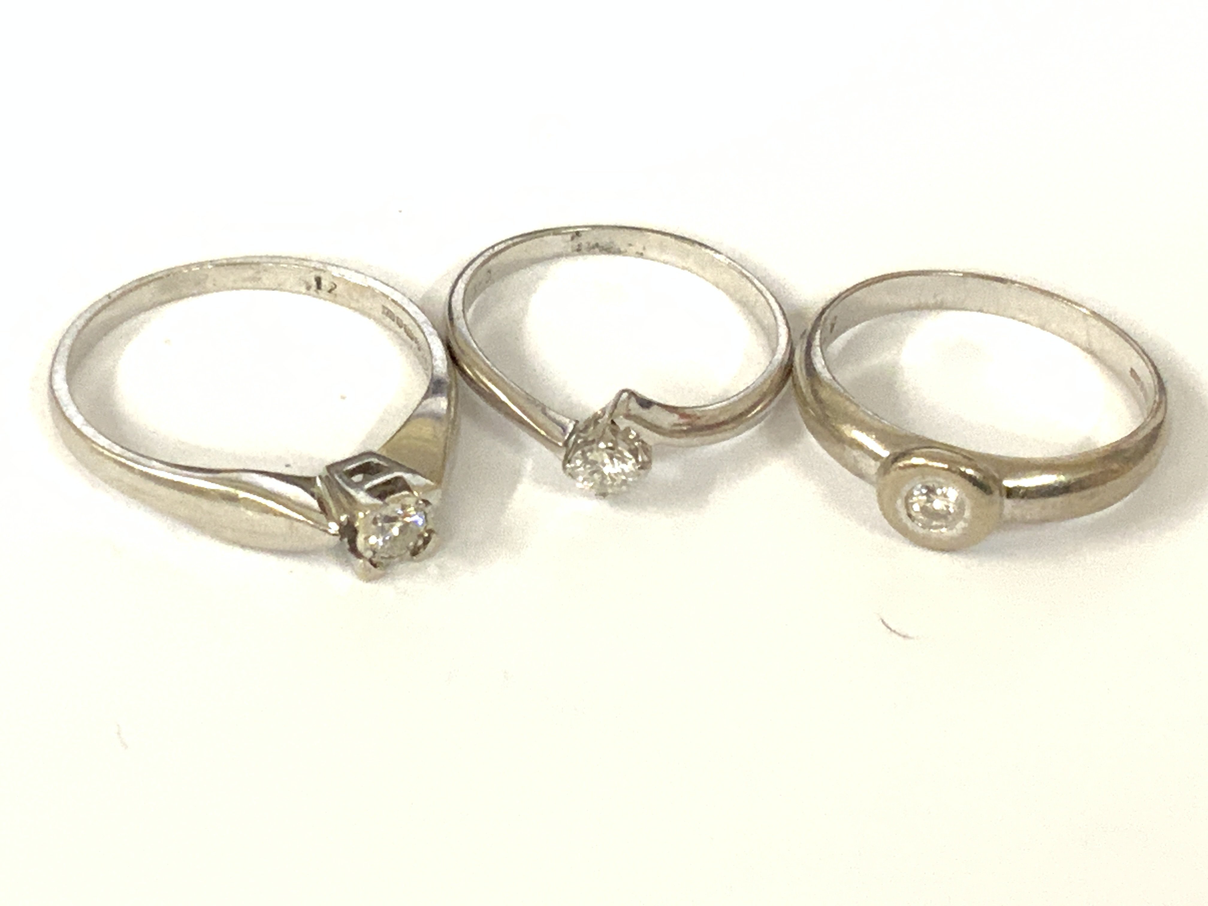Three 9ct white gold diamond solitaire rings. Approx ring size K,M,N. Approx 6.2g. Postage category A