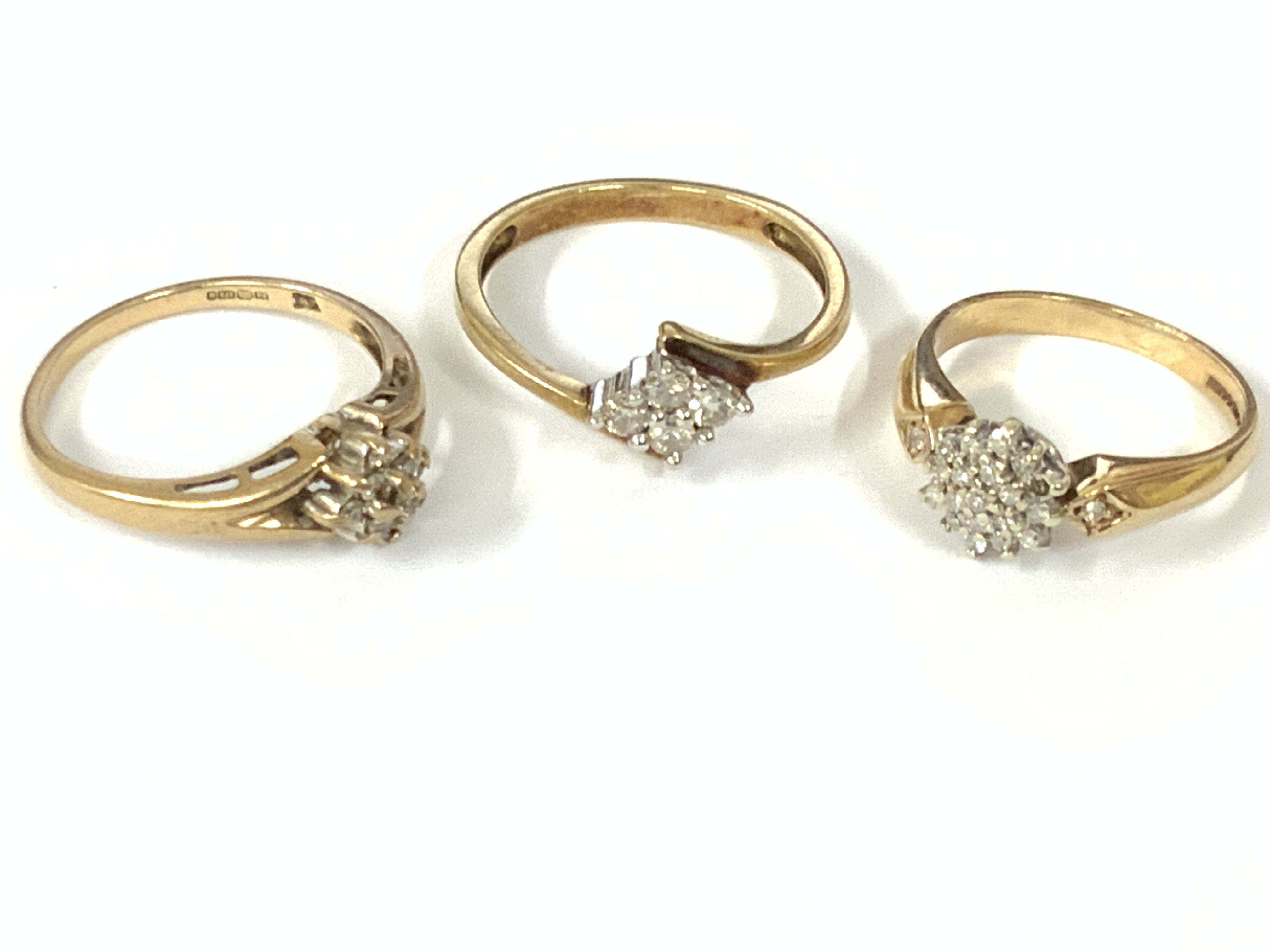 Three 9ct gold diamond cluster rings. Approx ring size J,M,O. Approx 6.2g. Postage category A