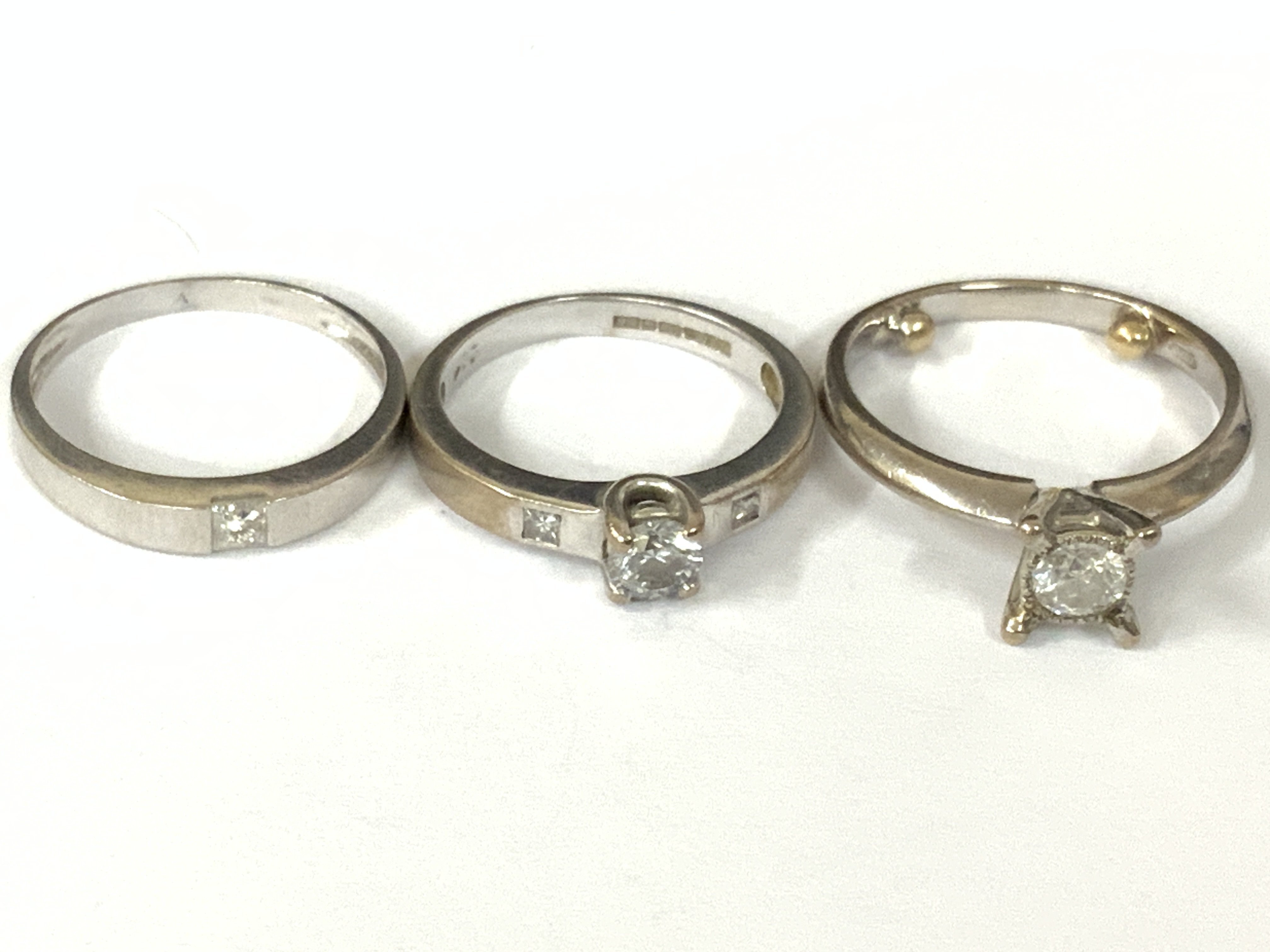 Three 18ct white gold diamond solitaire. Approx ring size I,J. Approx 8gm. Postage category A