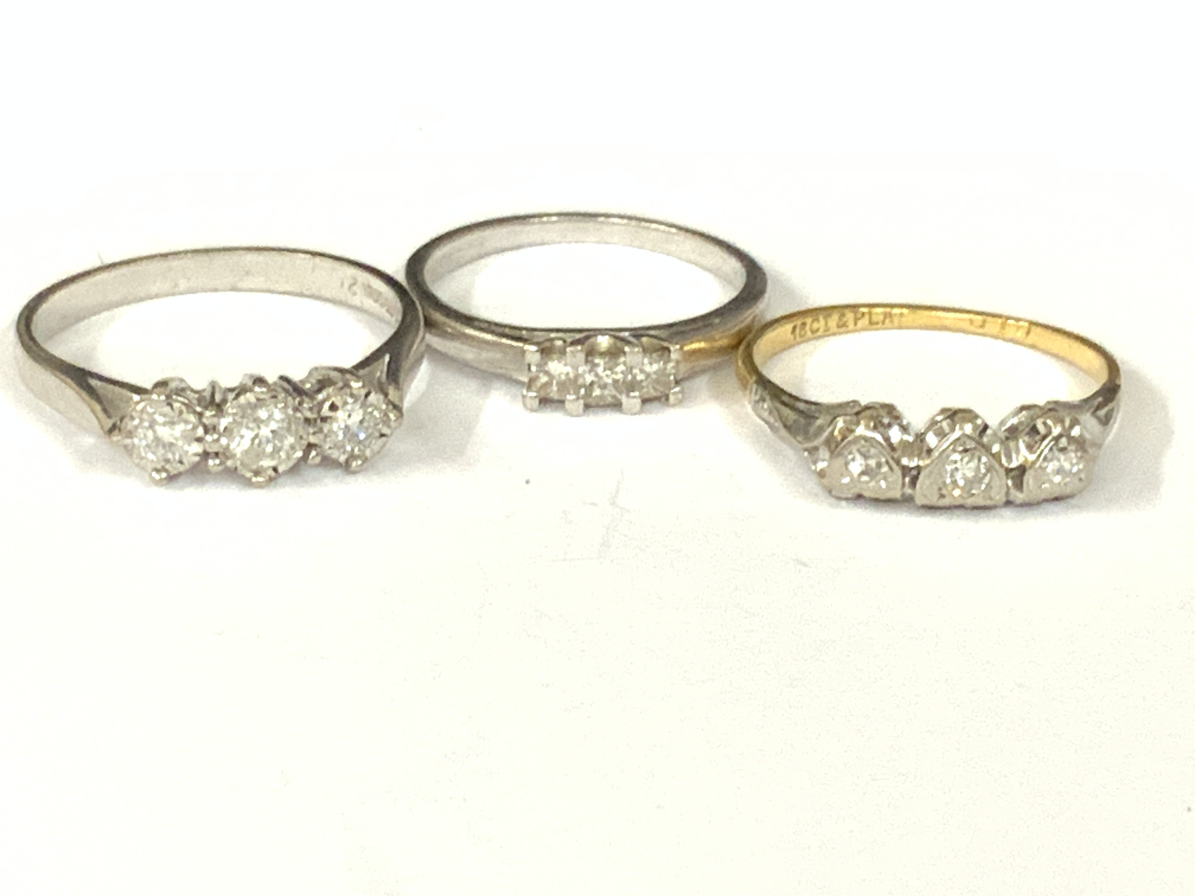 Three 18ct gold three stone diamond rings. Approx ring size K,M,O. Approx 8gm. Postage category A