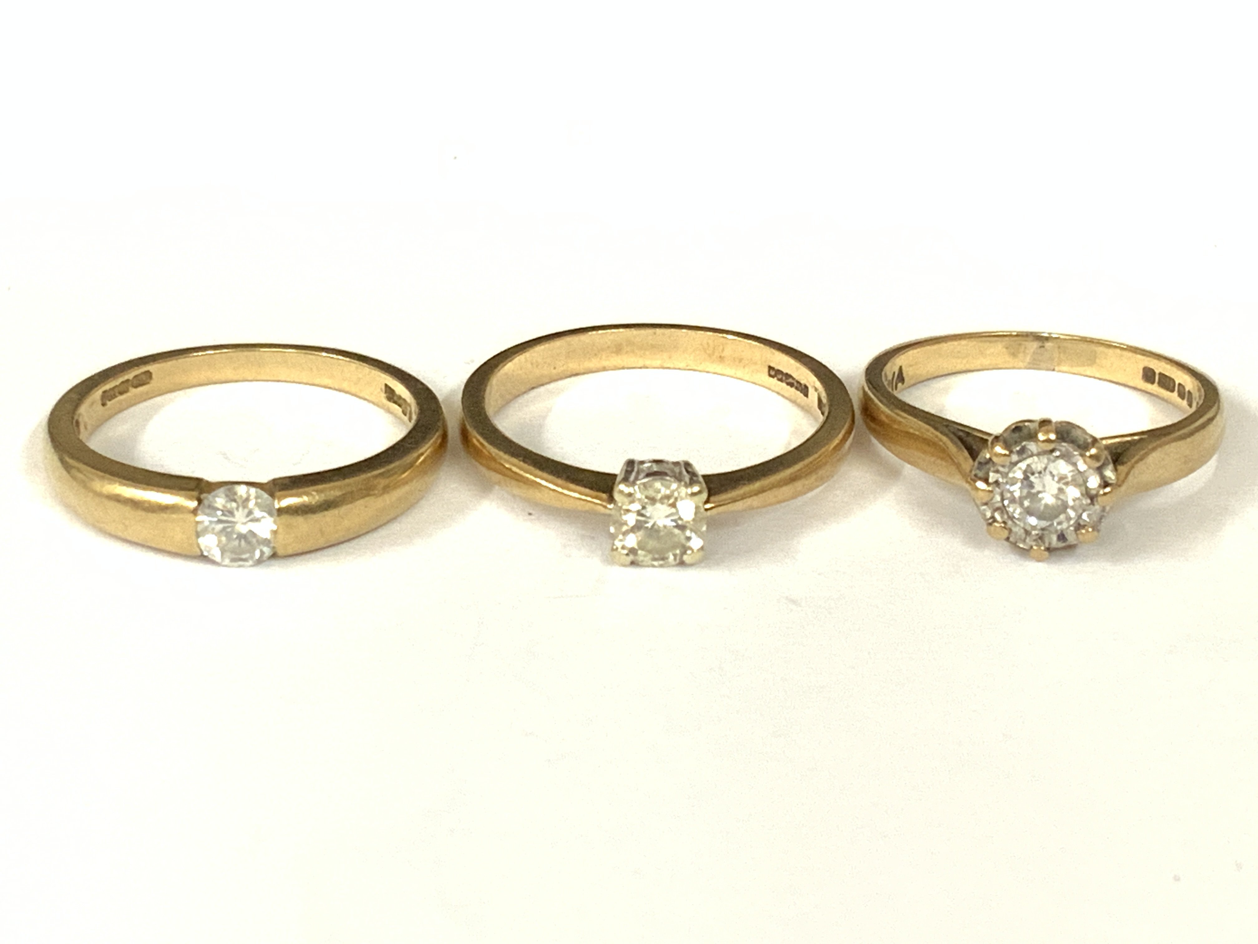 Three 9ct gold diamond solitaire rings. Approx ring size J,L,M. Approx 6.4g. Postage category A