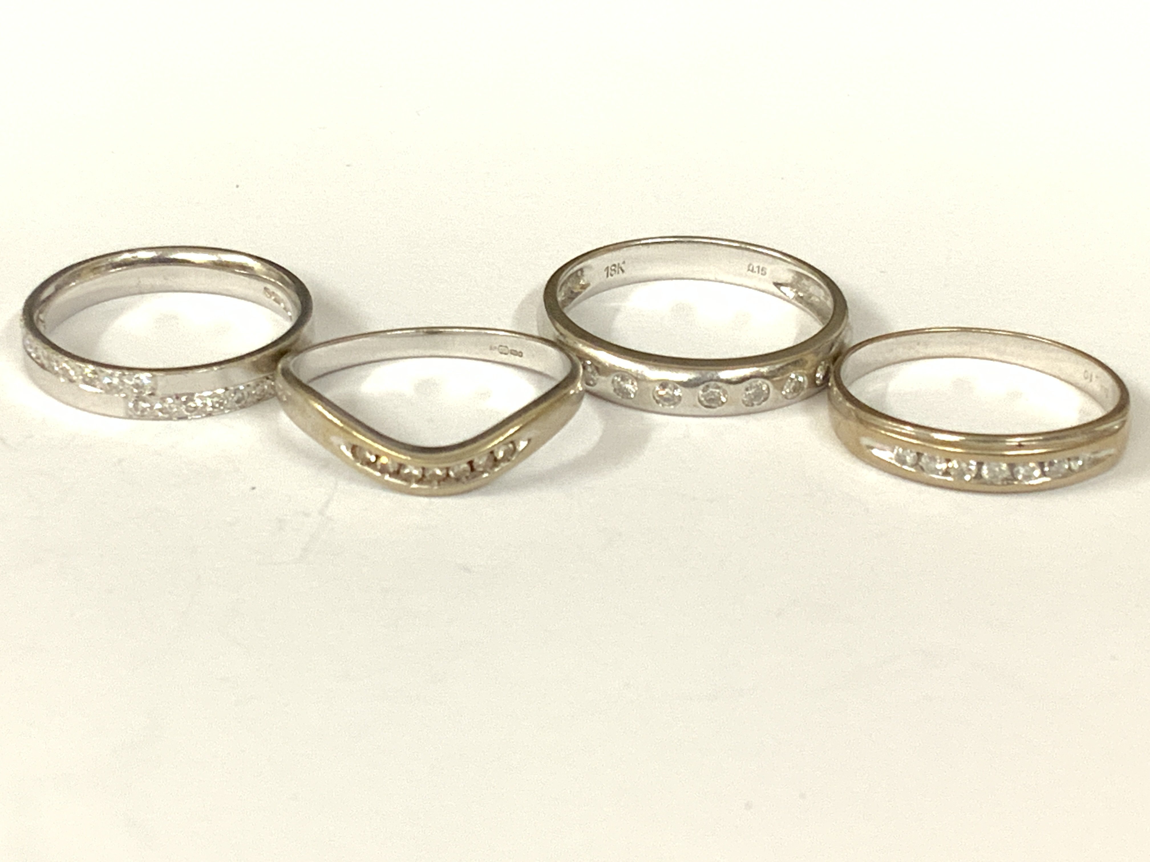 Four 18ct white gold diamond half hoop rings. Approx ring size I,K,N,L. Approx 8.9g. Postage category A