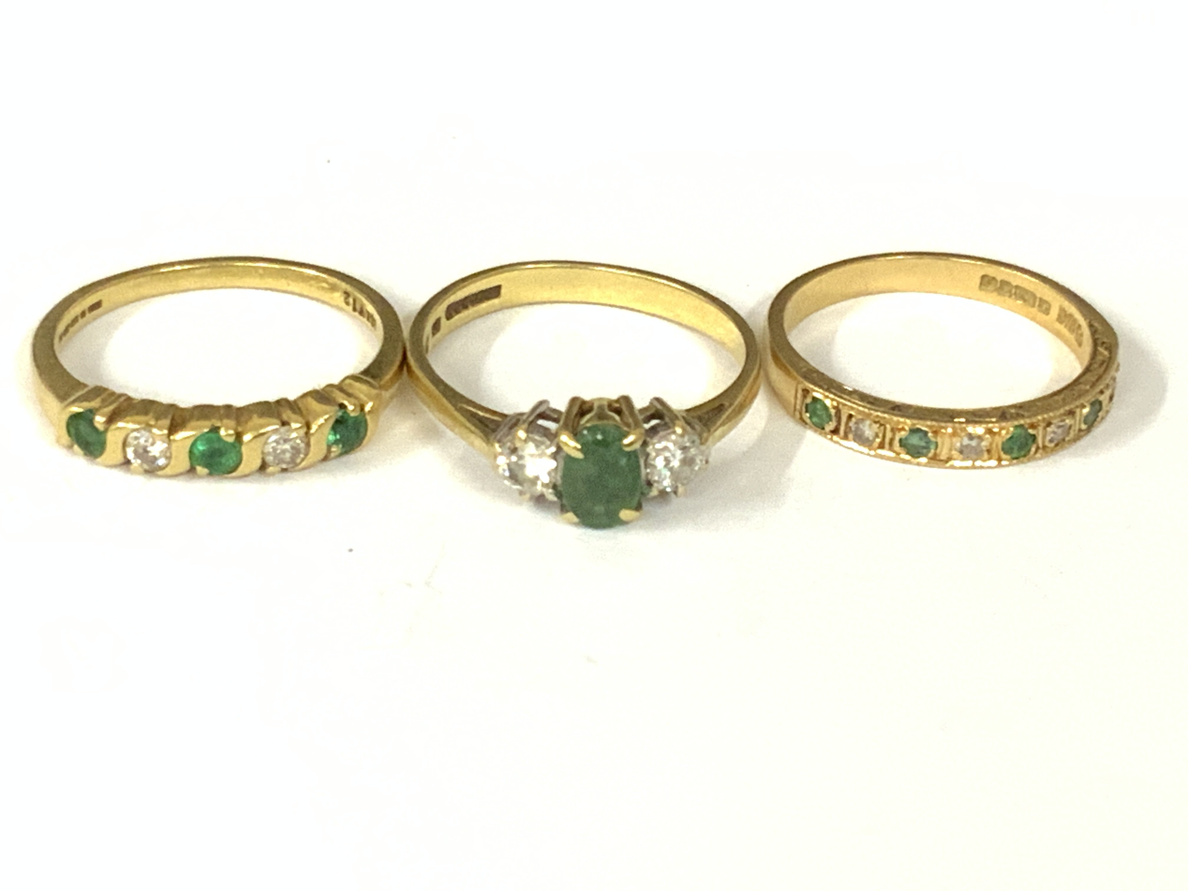 Three 18ct gold emerald / diamond rings. Approx ring size M,N,O. Approx 8.3g. Postage category A