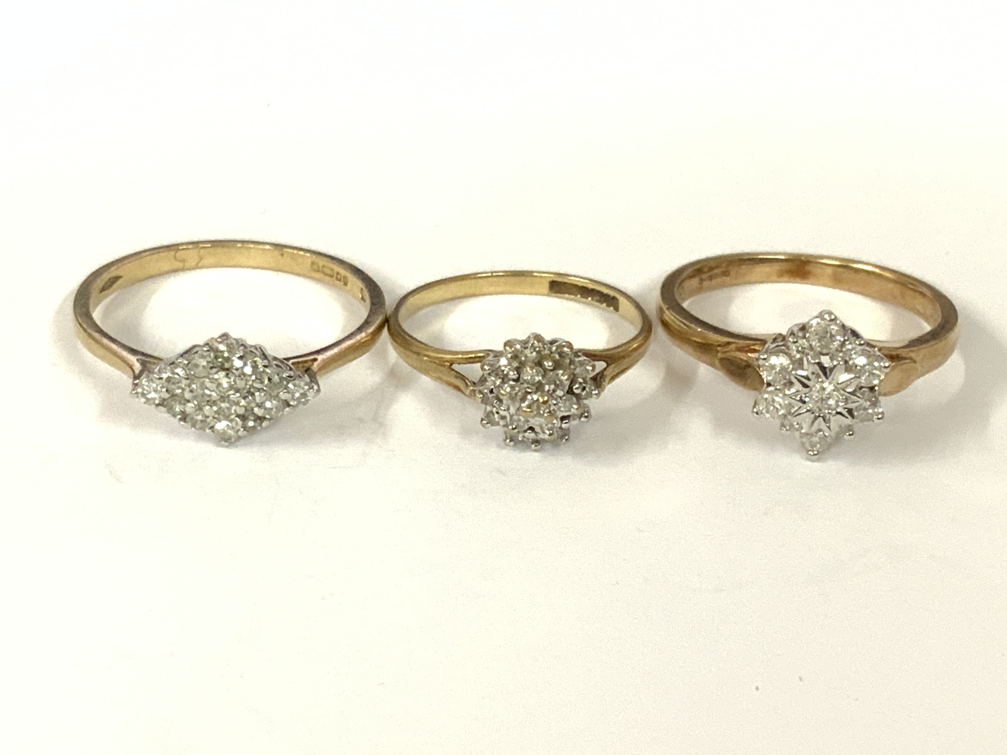 Three 9ct gold diamond cluster rings. Approx ring size L,O,R. Approx 6.6g. Postage category A