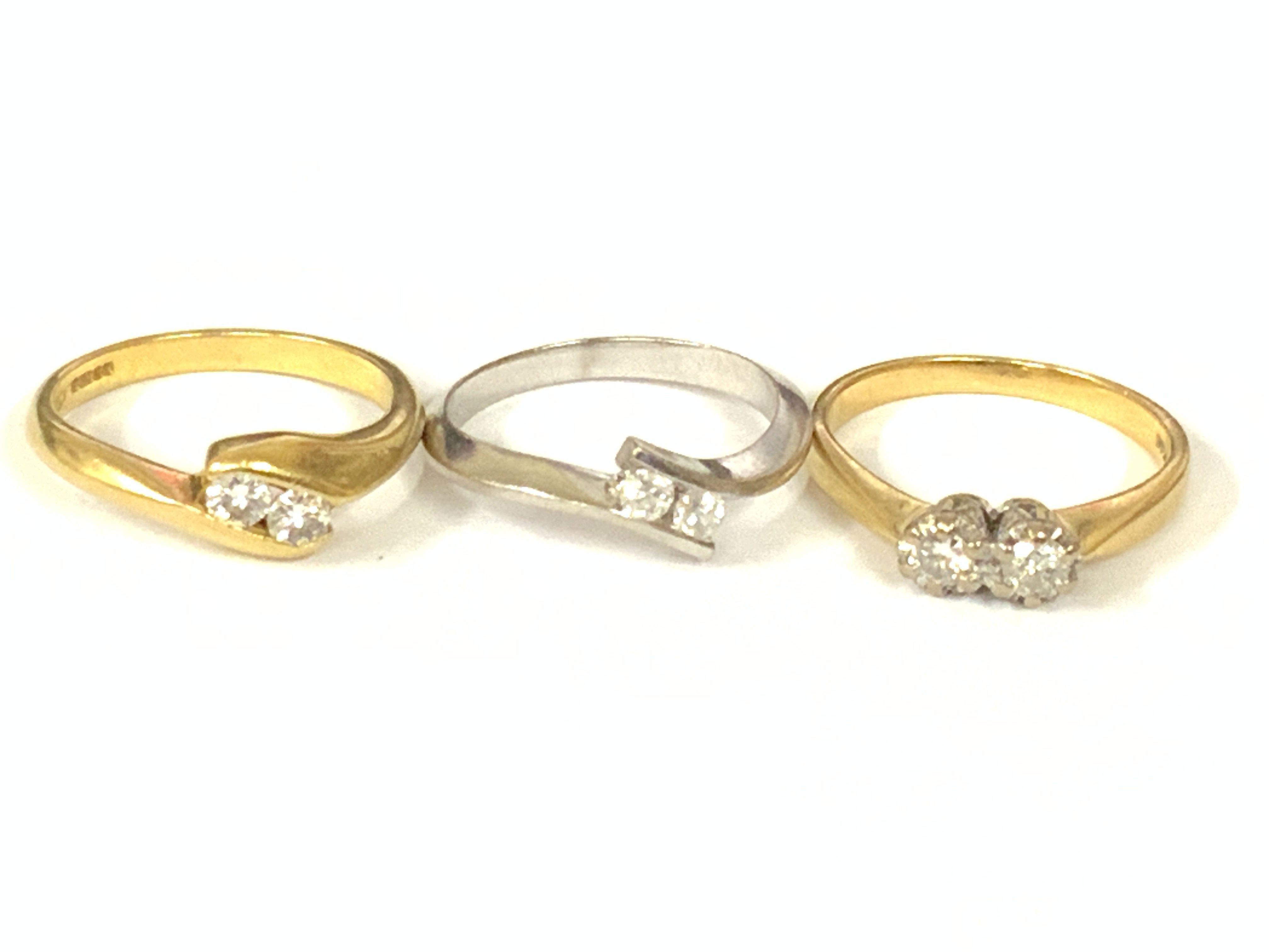 Theee 18ct gold two stone diamond rings (x1 white gold). Approx ring size M. Approx 11gm. Postage category A