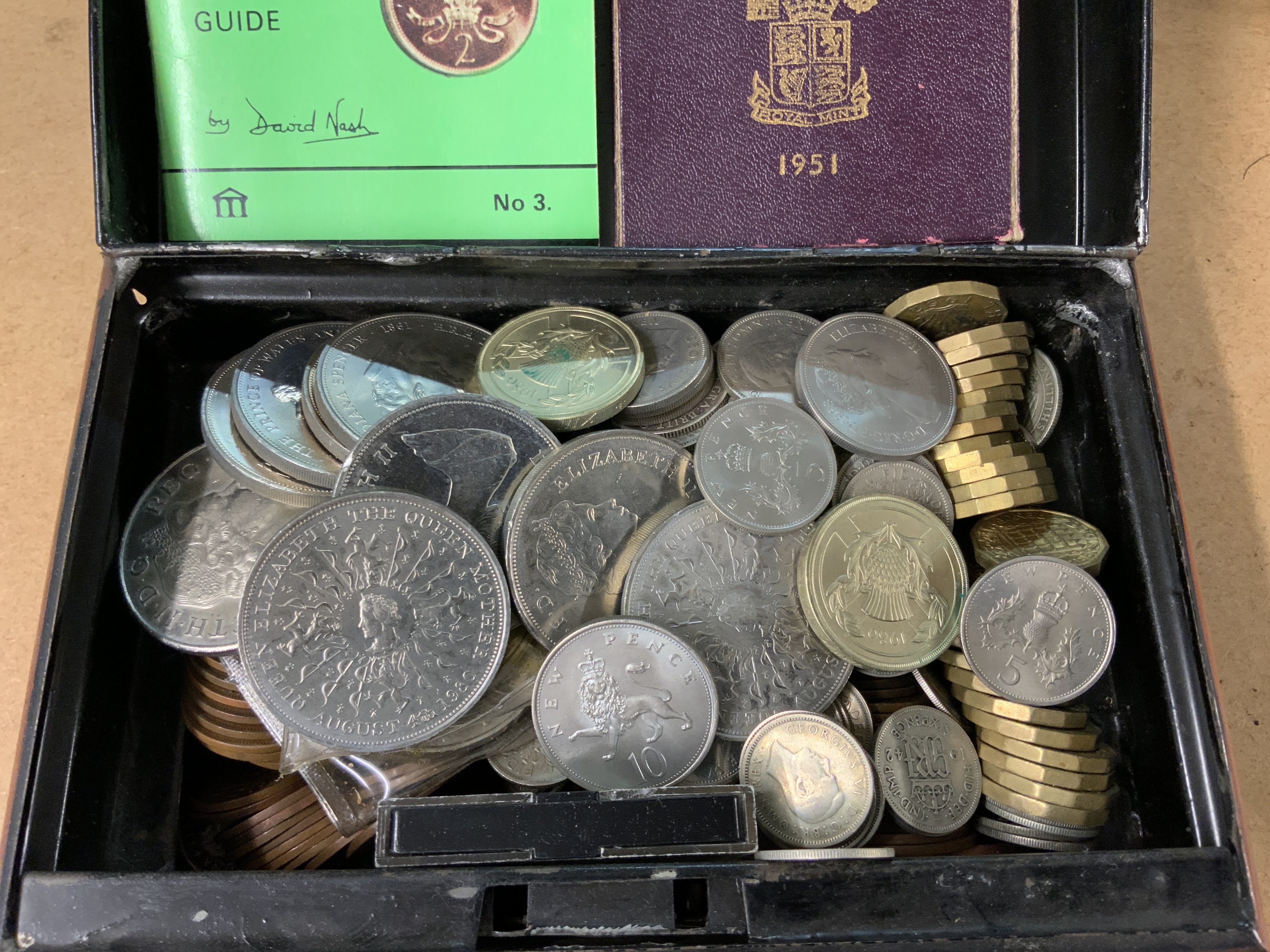 A tin of British coinage.