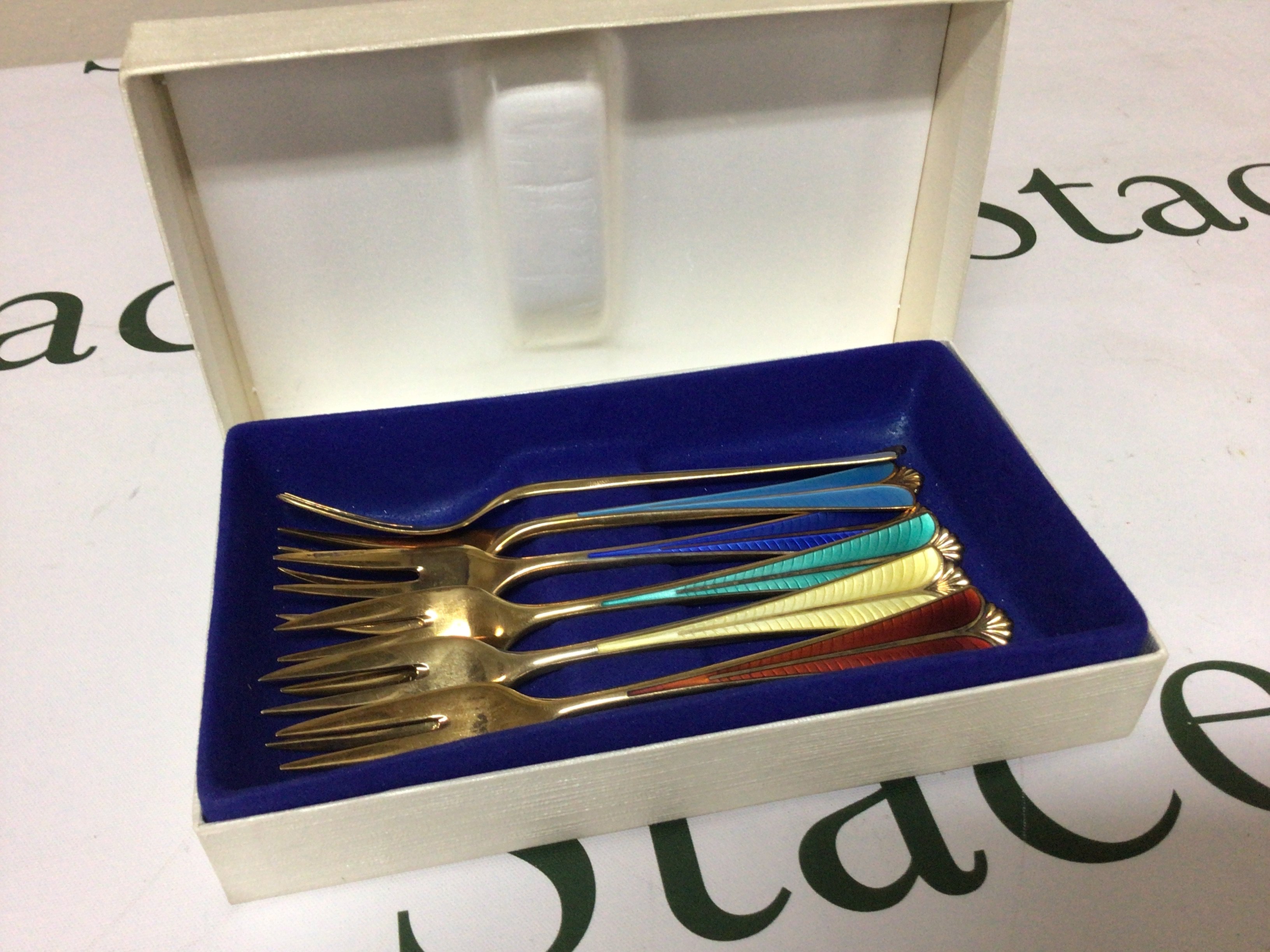 A cased set of six quality Silver gilt and enamel mid 20th century design folks each with different colours of enamel David Anderson Bergen Norway.