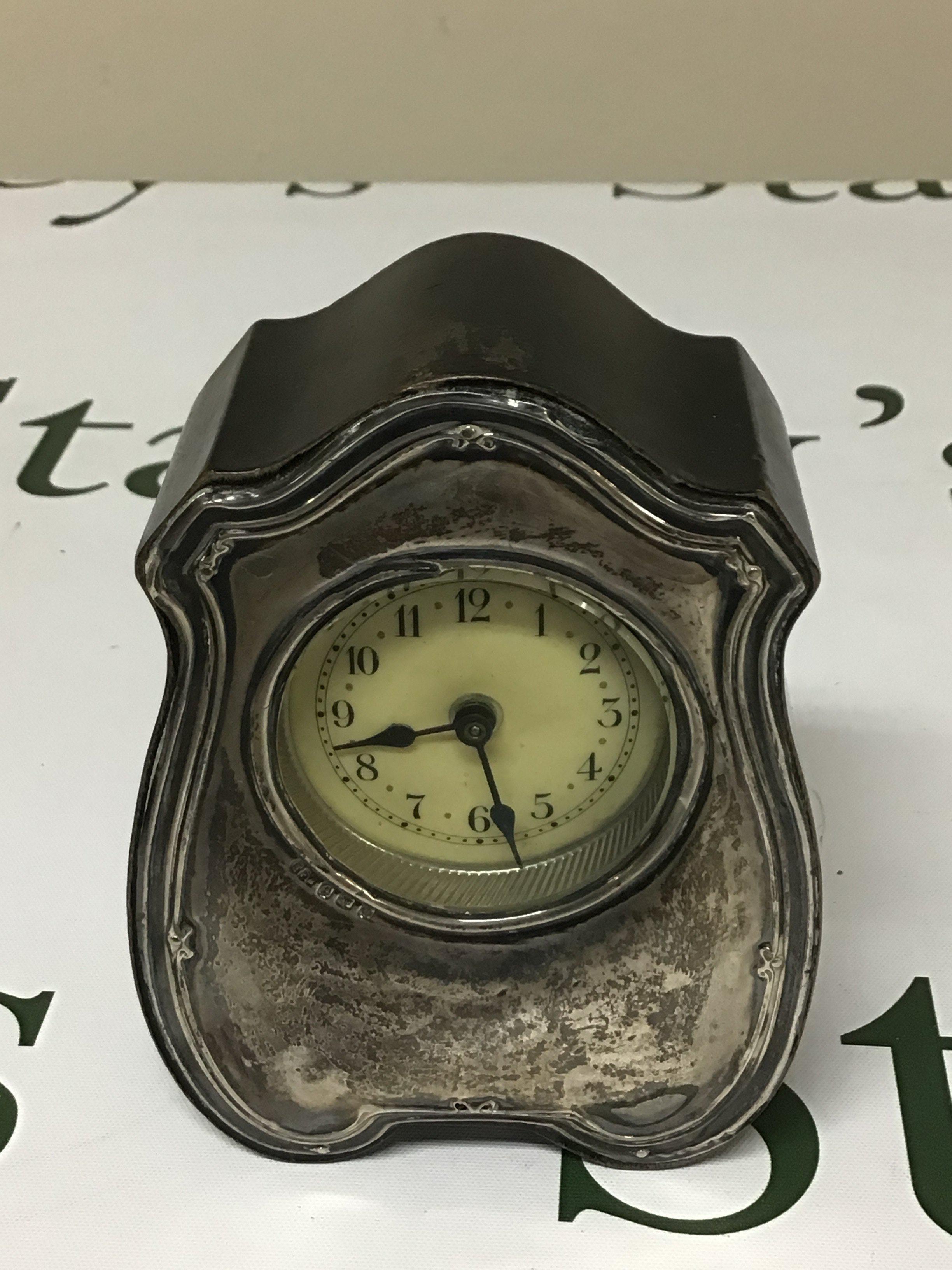 A silver mounted 1913 alarm clock not seen working Birmingham hallmarks. Height 12cm.