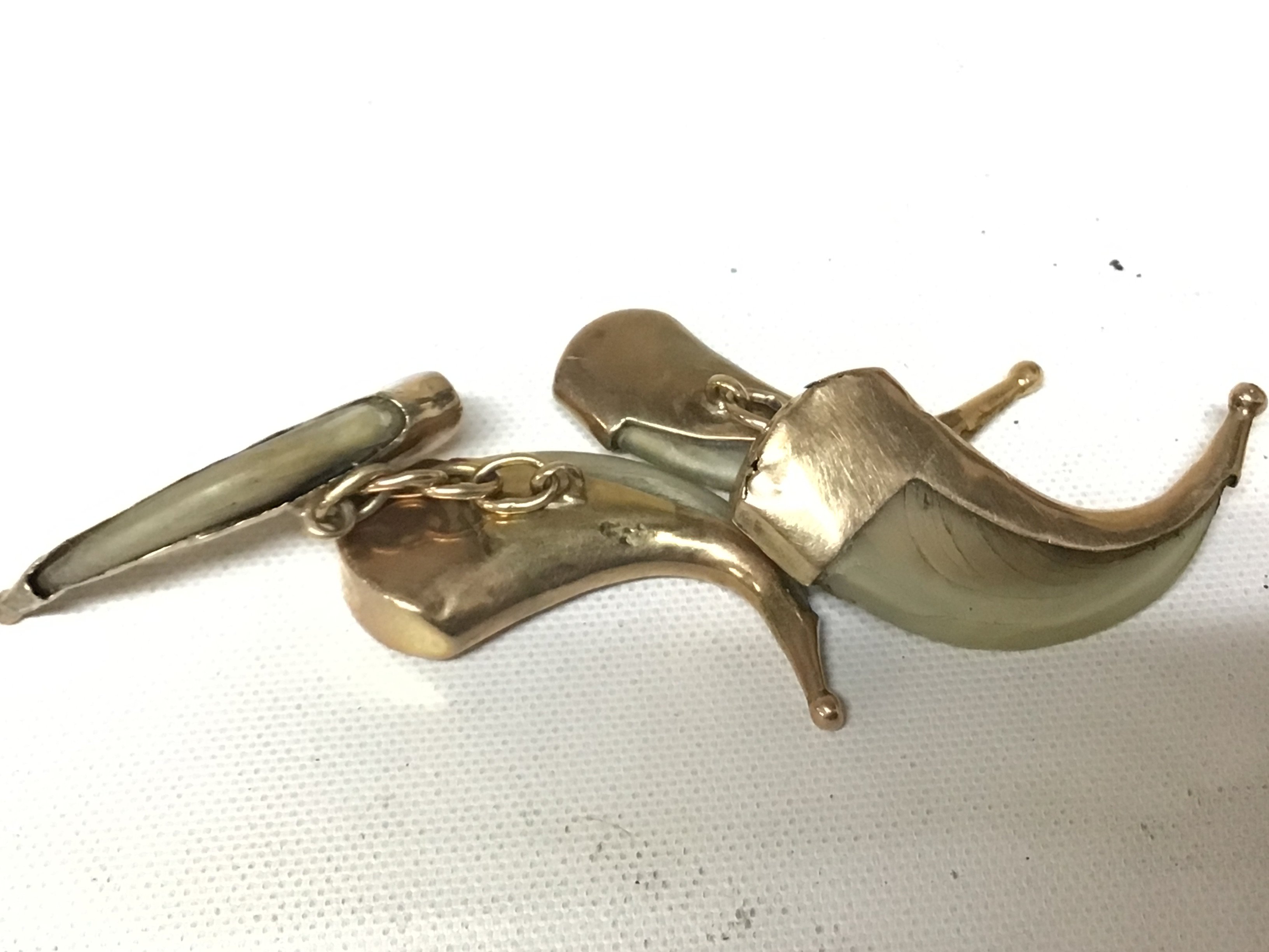 A pair of gold mounted claw cufflinks. Unmarked.