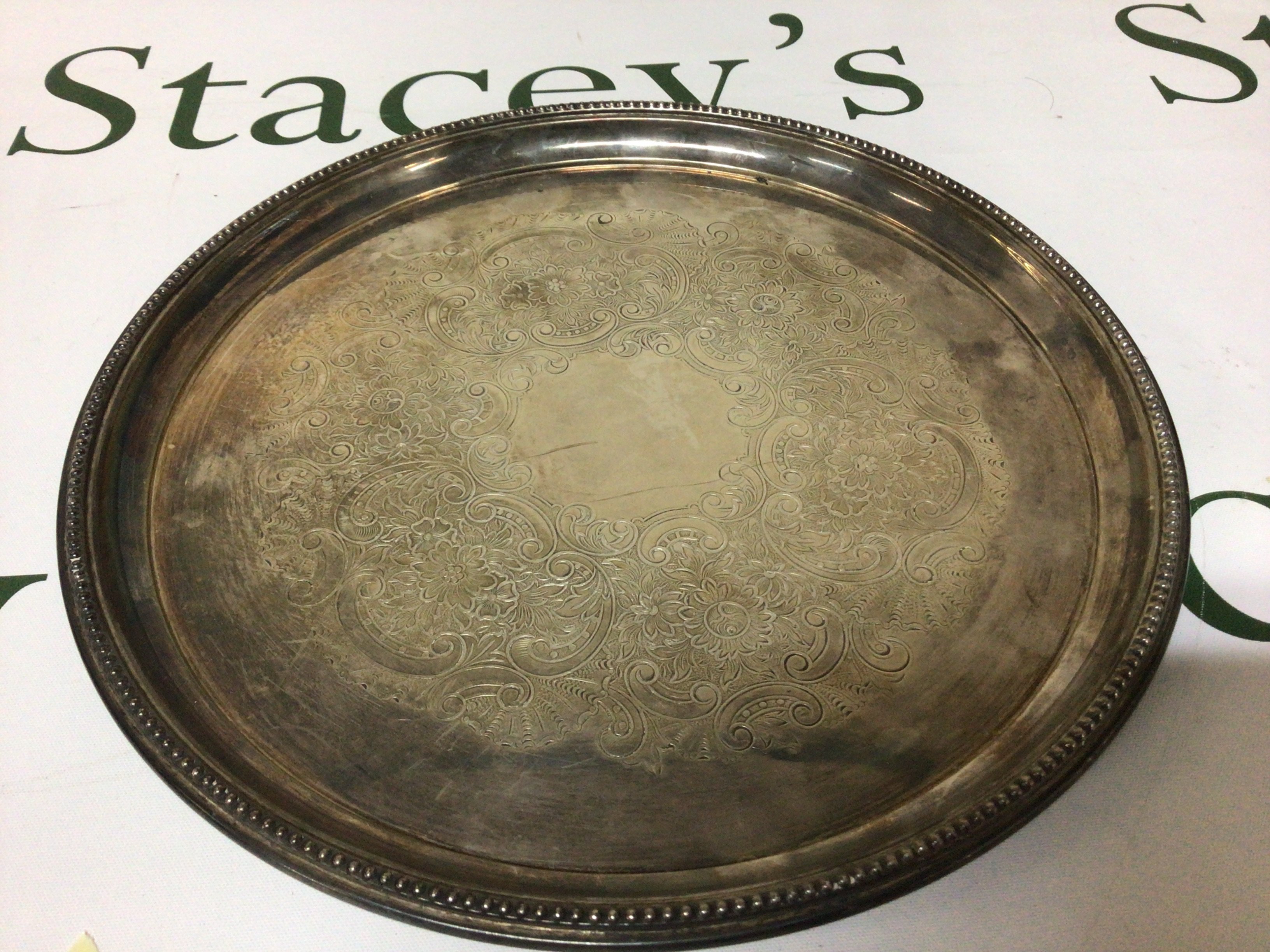 A Silverctray of circular shape Birmingham hallmarks with a scroll pattern and beaded edge weight 420g diameter 26cm