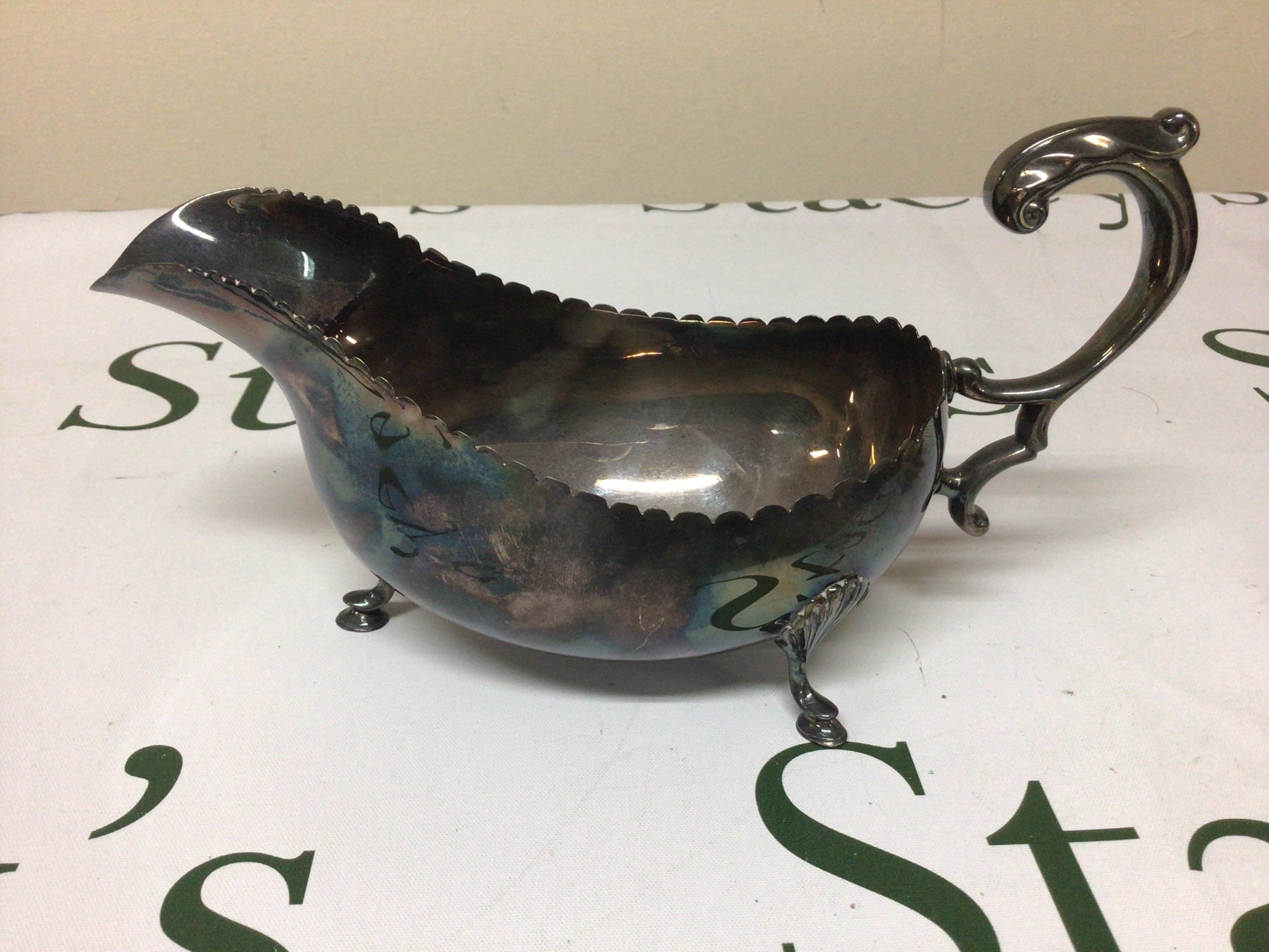 An Irish Silver sauce boat with a shaped edge scroll handle and feet. Dublin hallmarks. Weight 250g