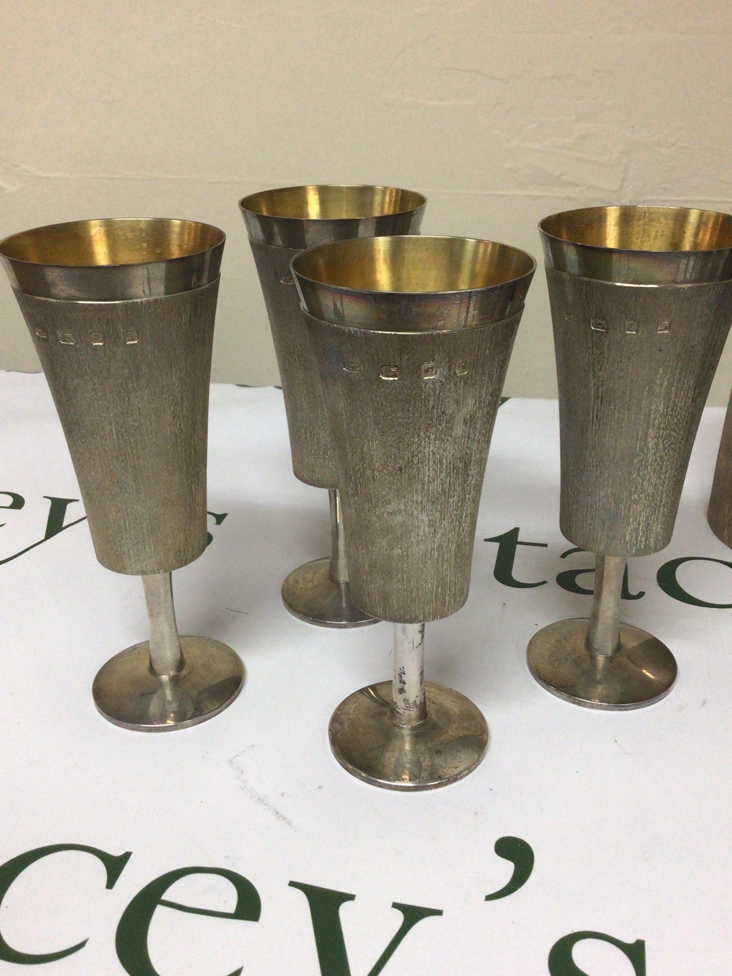 A set of four parcel guilt Silver mid 20th century design wine goblets on stems with circular foot by Christopher Lawrence (b1936) Liveryman for the Worshipful Goldsmith Company Studied Central School of Arts & Crafts. Weight 840g height 16cm