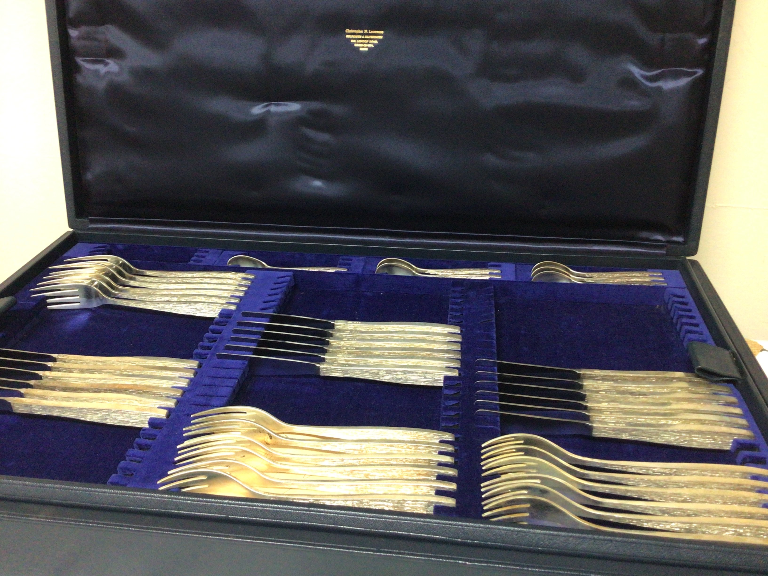 A Fine quality Silver Mid 20th Century design canteen of culture six place setting by Christopher Lawrence (b1936) Liveryman for the Worshipful Goldsmith Company Studied Central School of Arts & Crafts. All solid silver with a textured finish knifes with steel blades in a fitted two tier case Christopher Lawrence. Total cutlery weight 4.5kg approximately.