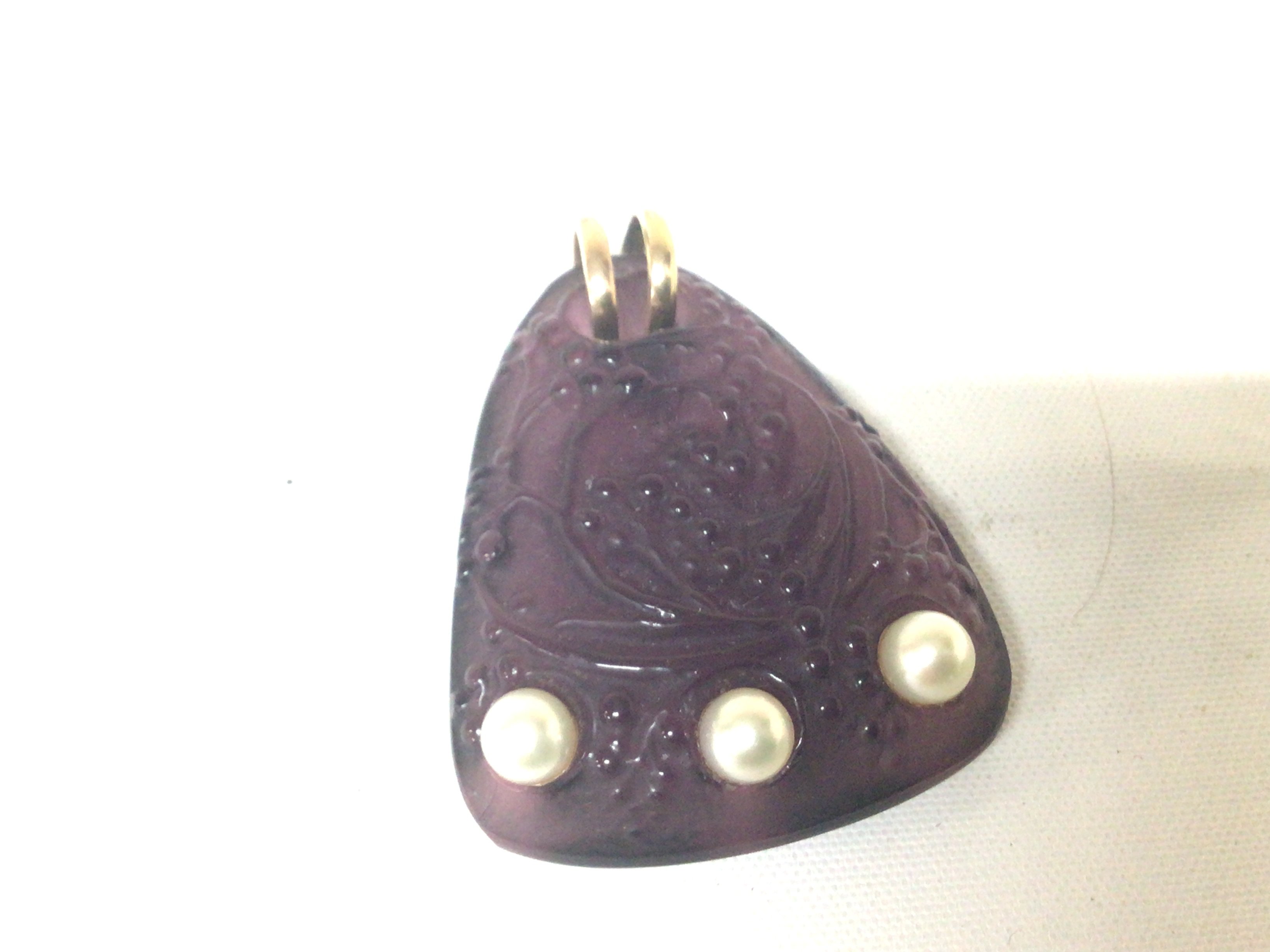 A Lalique glass pendent set with three pearls the reverse signed Lalique 5cmx3.8cm approximately.