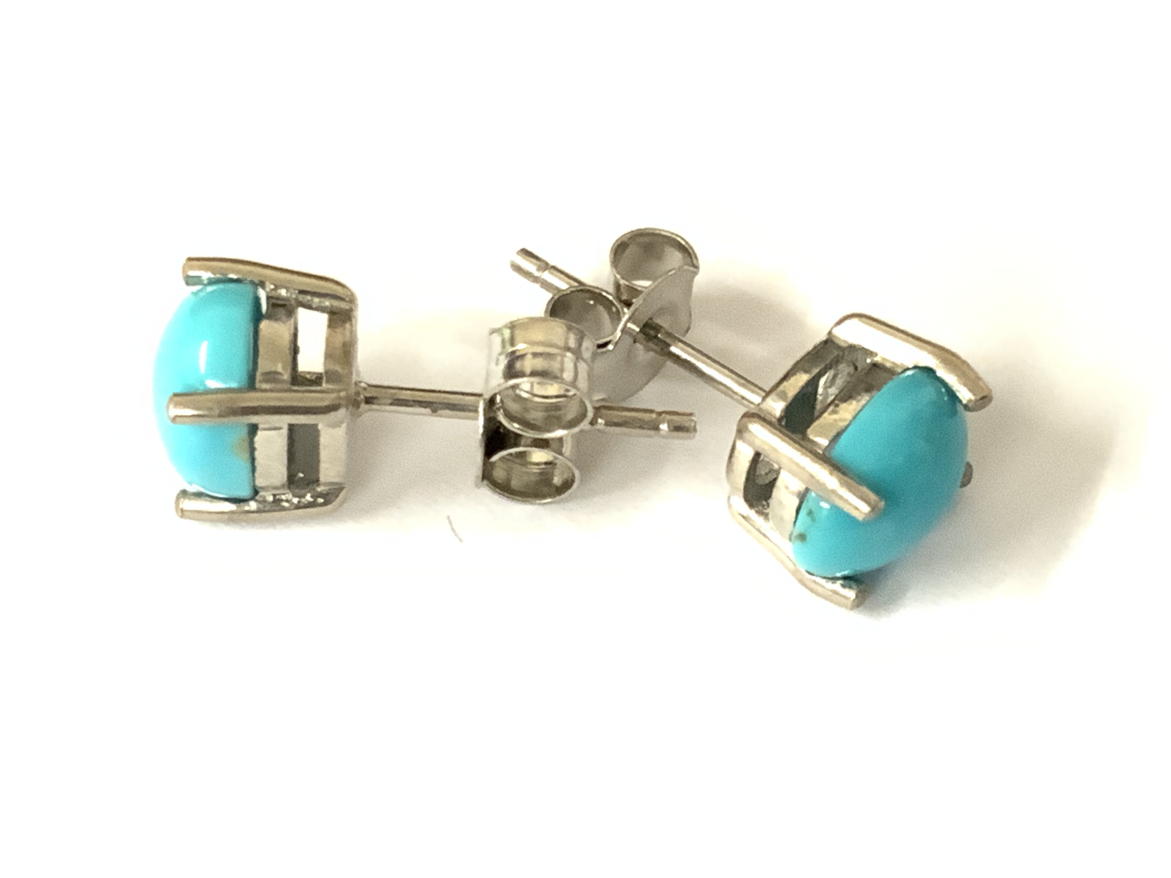 Pair of oval cabochon turquoise studs in silver. Postage category A