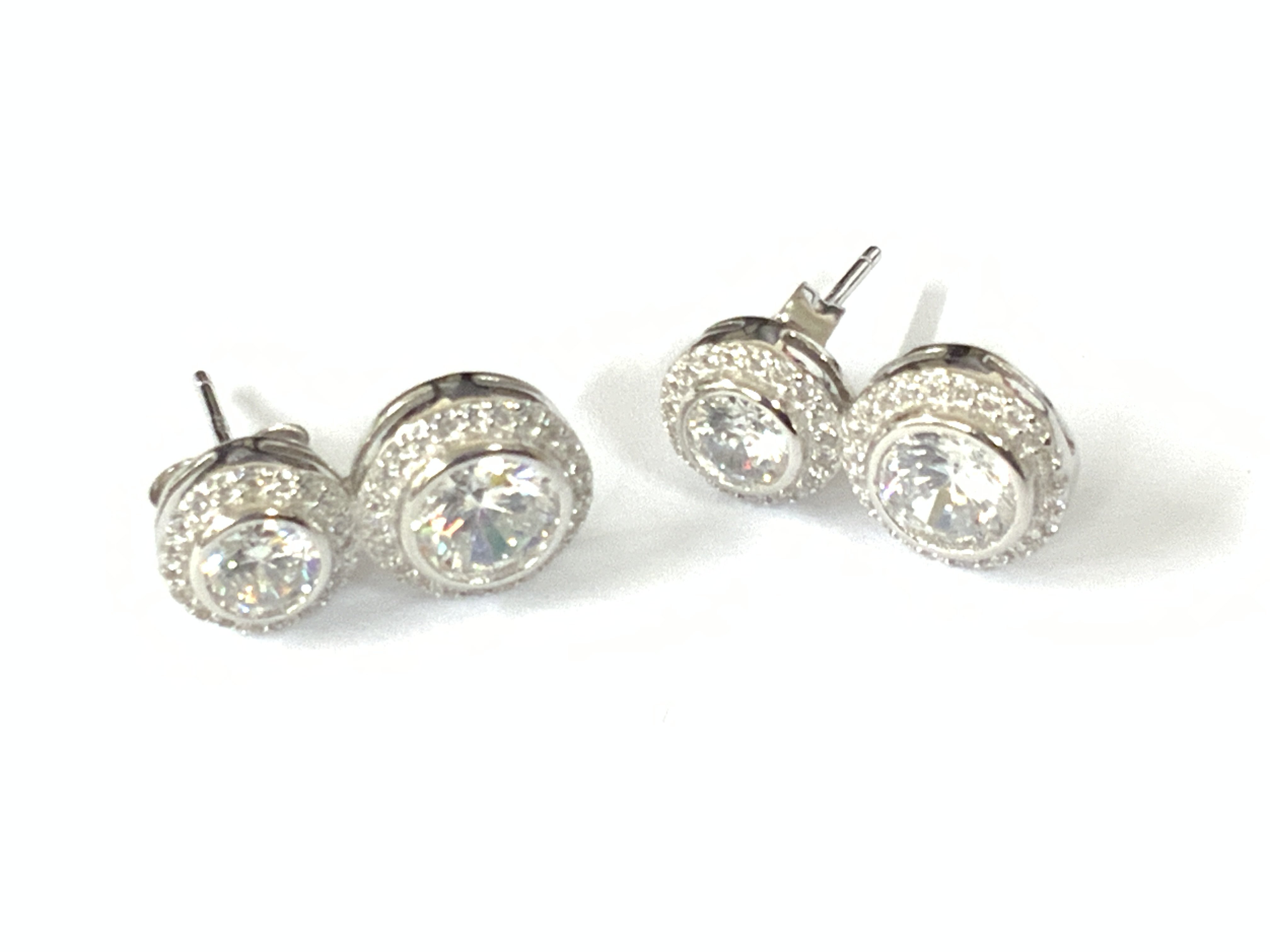 Pair of silver double drop white CZ halo earrings. Postage category A