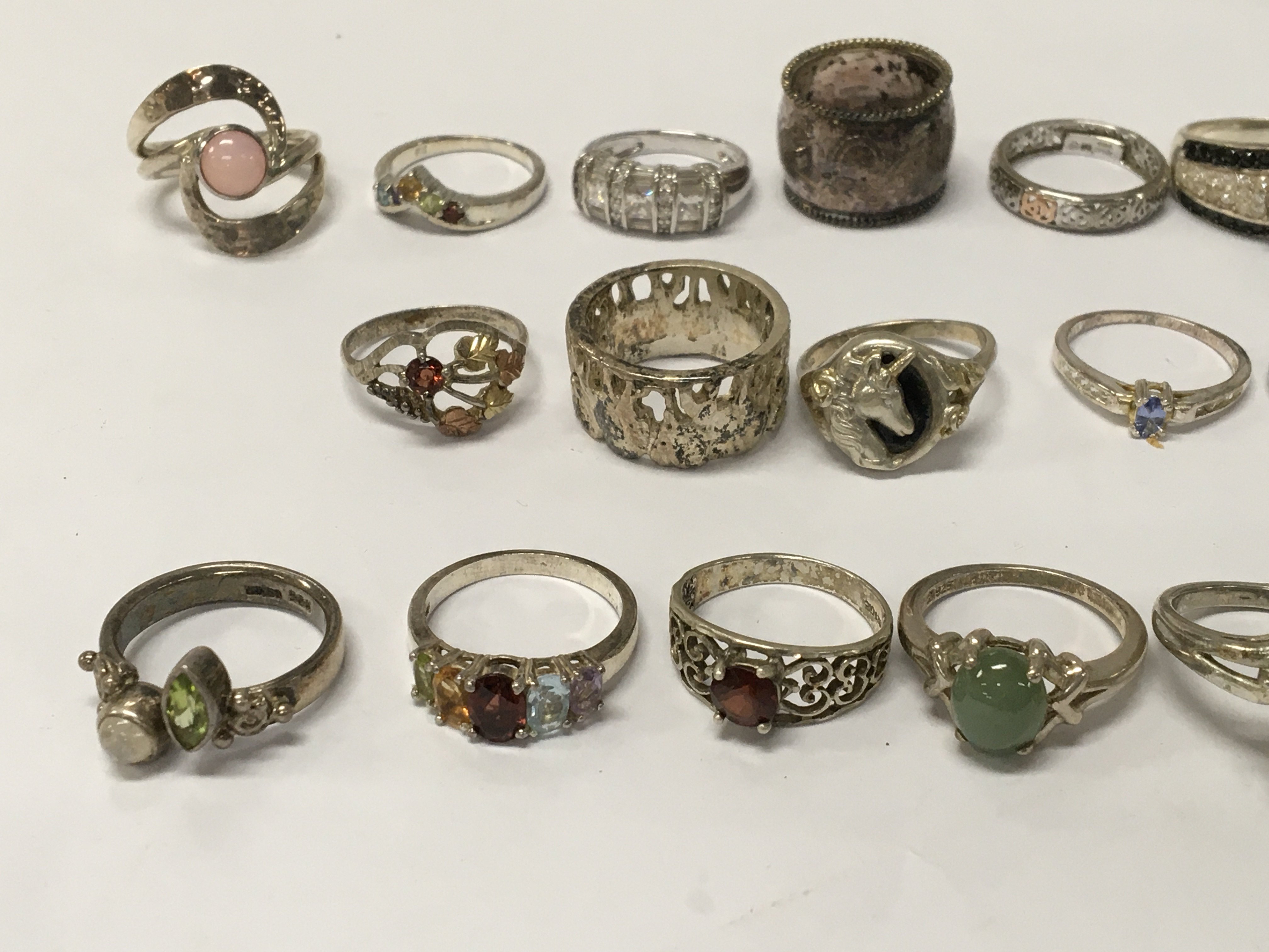 A collection of 19 silver dress rings
