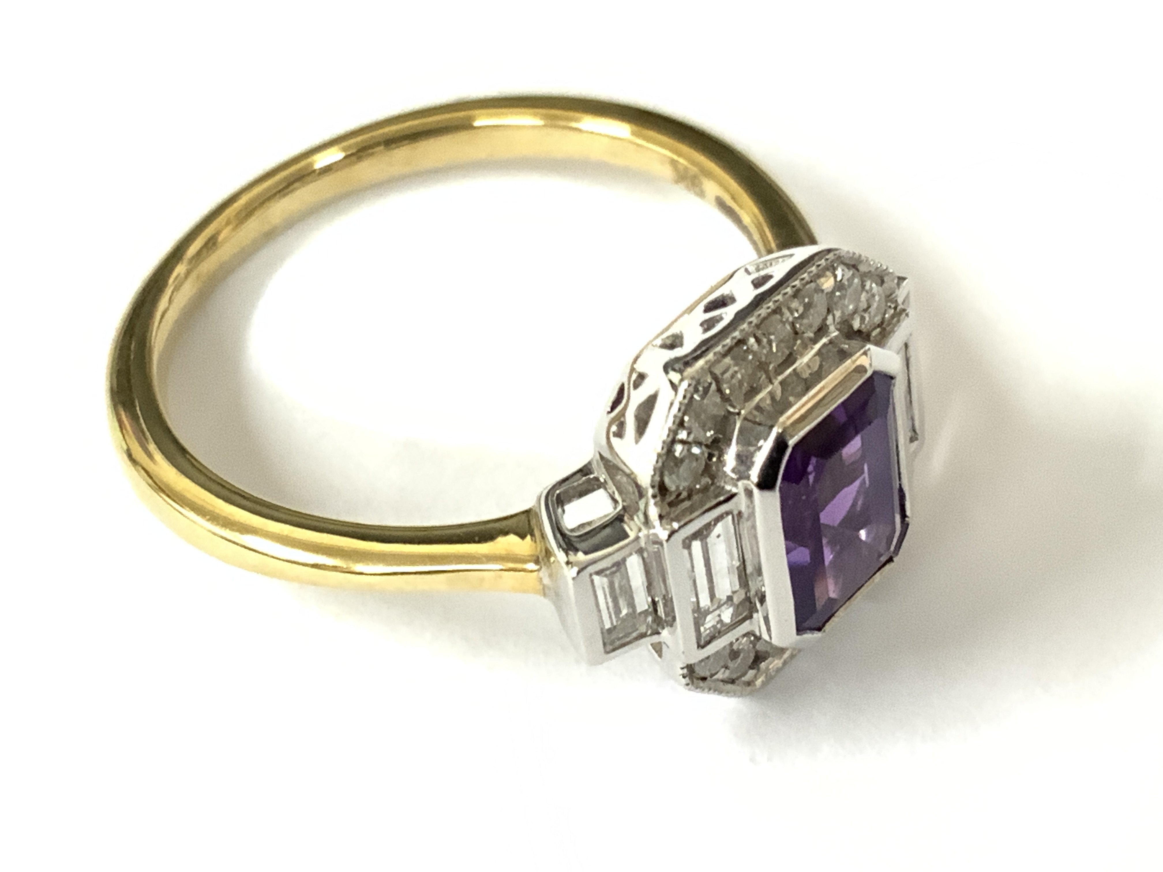 9ct yellow and white gold art deco style dress ring set with a step cut amethyst and baguette cut and RBC diamonds. Amethyst 0.78ct. Diamonds 0.52ct. Approx ring size N. Postage category A