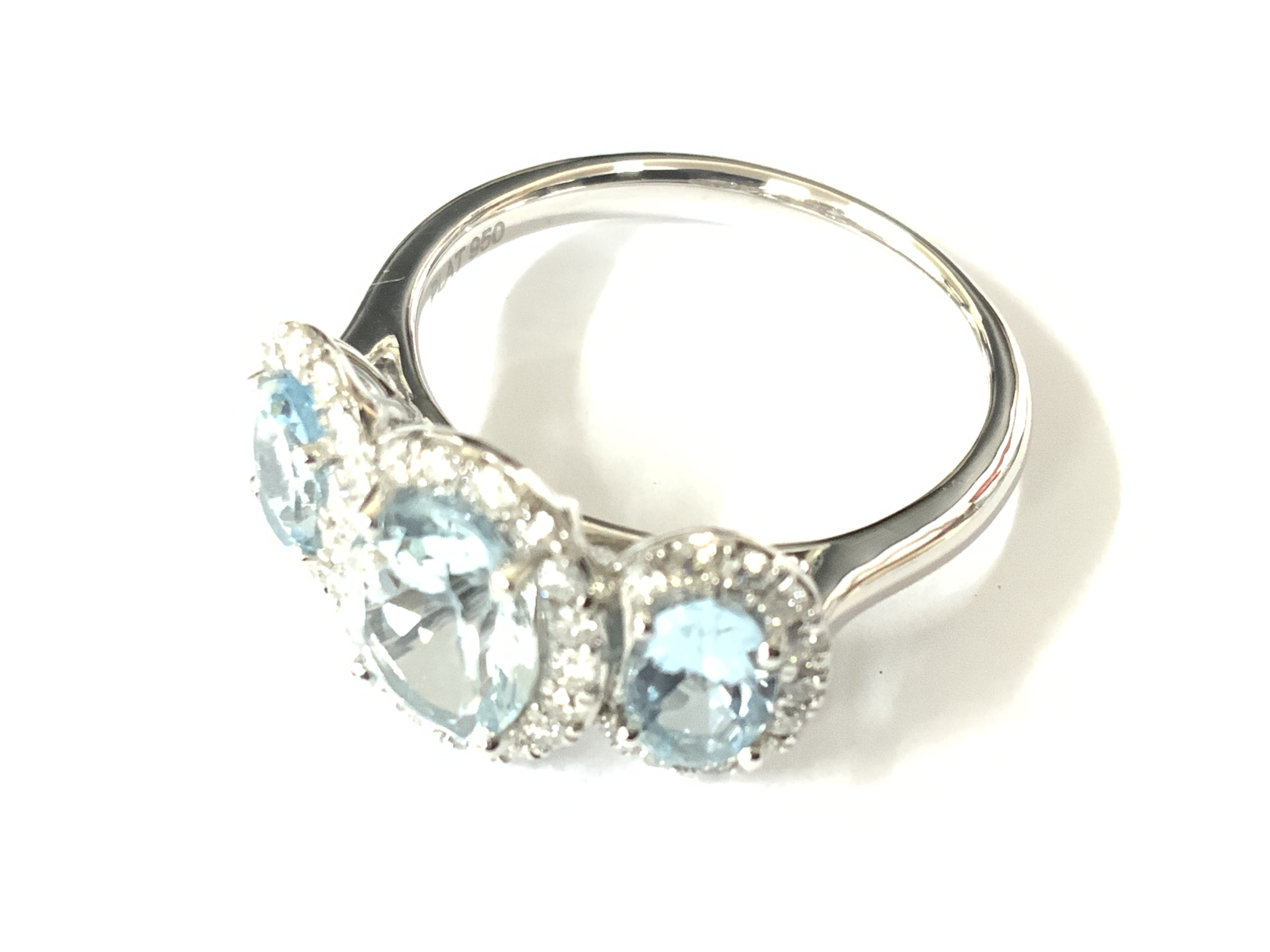 Platinum trilogy ring set with 3 oval aquamarines and RBC diamonds. Aquamarine 2.13ct. Diamonds 0.43ct. Approx ring size N. Postage category A