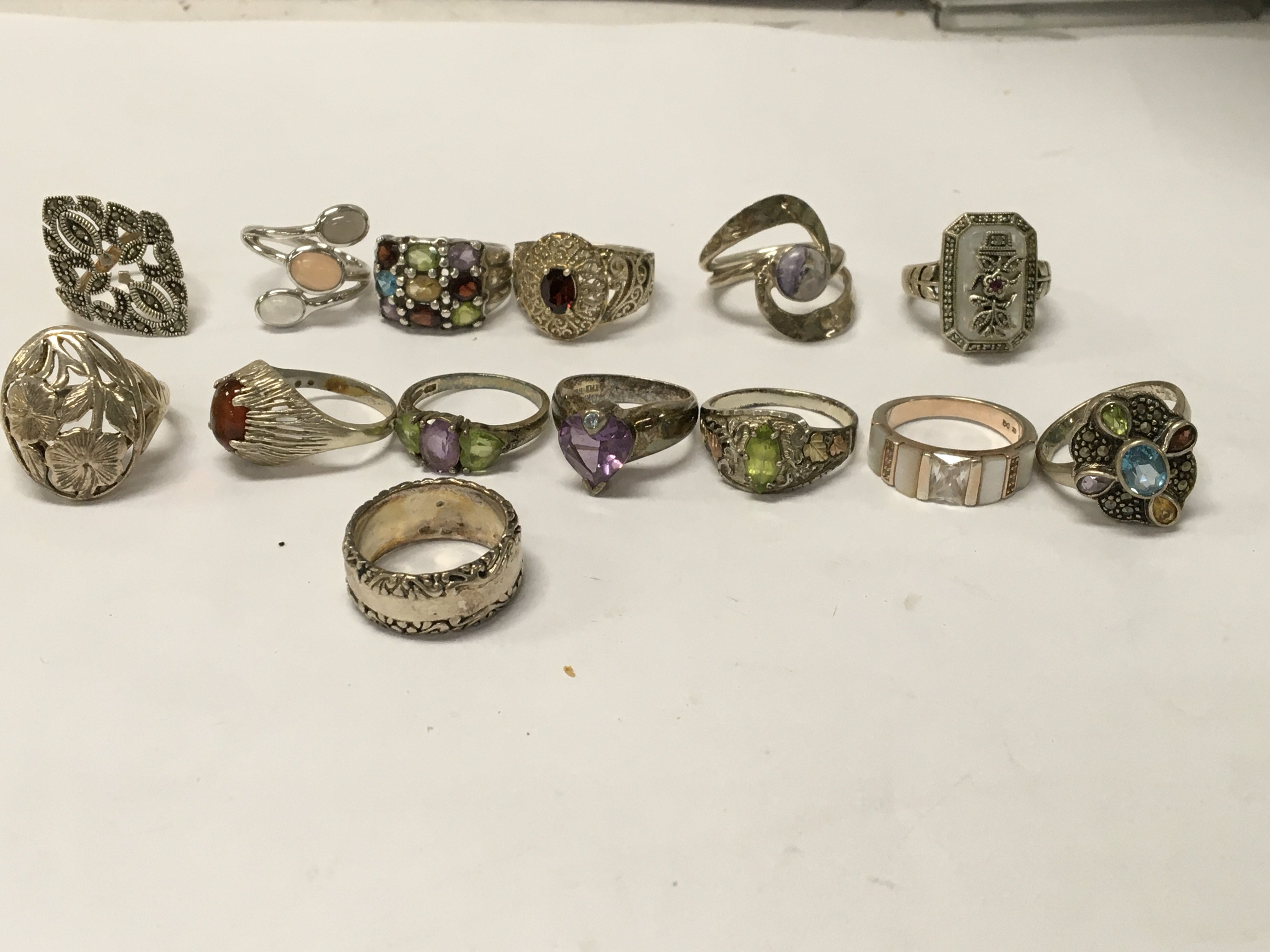 A collection of fourteen silver dress rings.